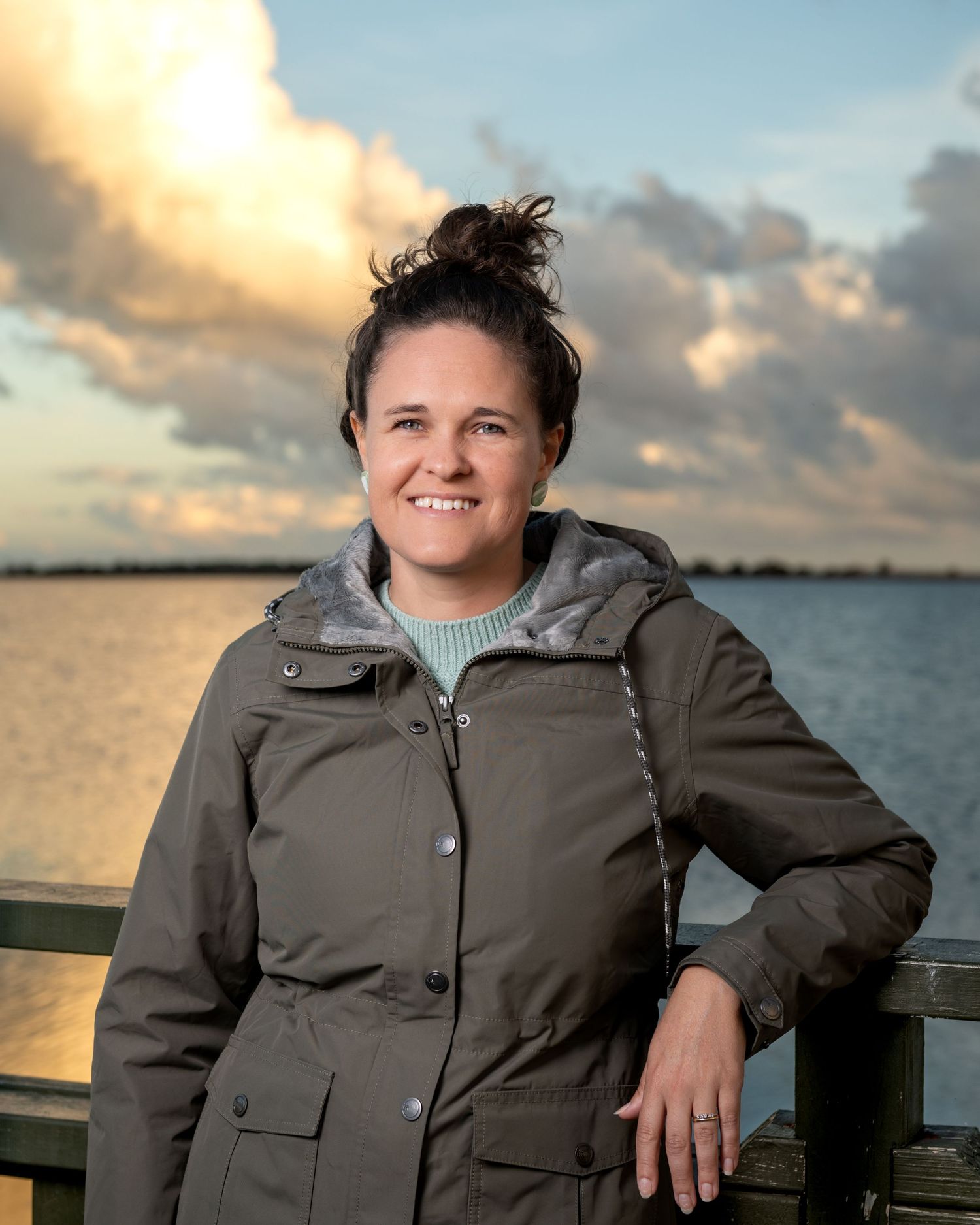 Outdoor portrait of a woman captured in natural, golden‑hour light.