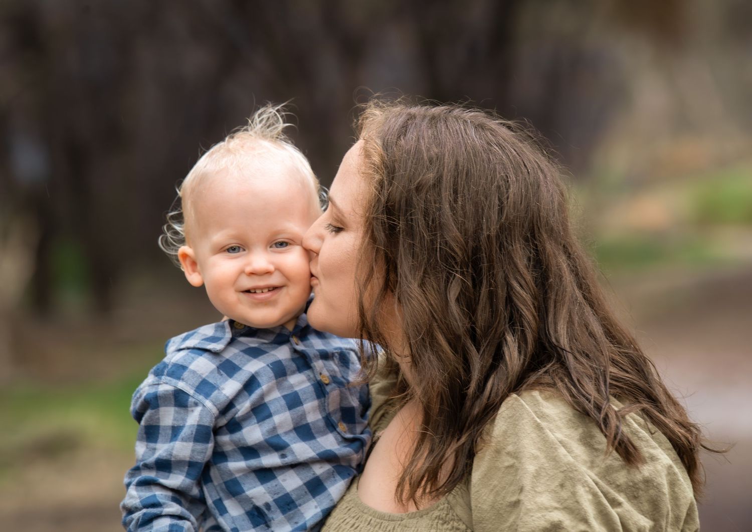Candid family photo of kids playing and laughing during a portrait session.