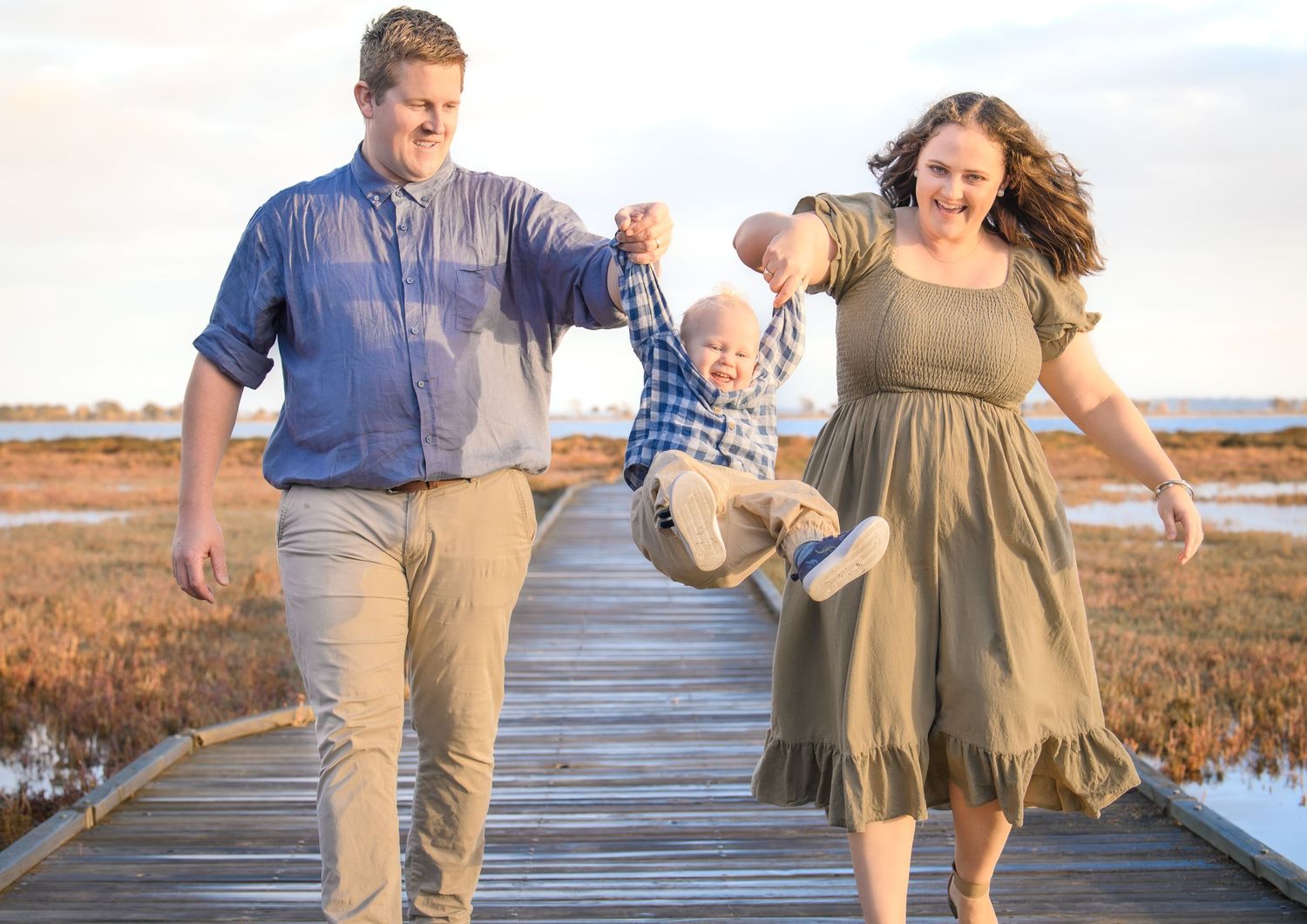 Candid family photo of kids playing and laughing during a portrait session.