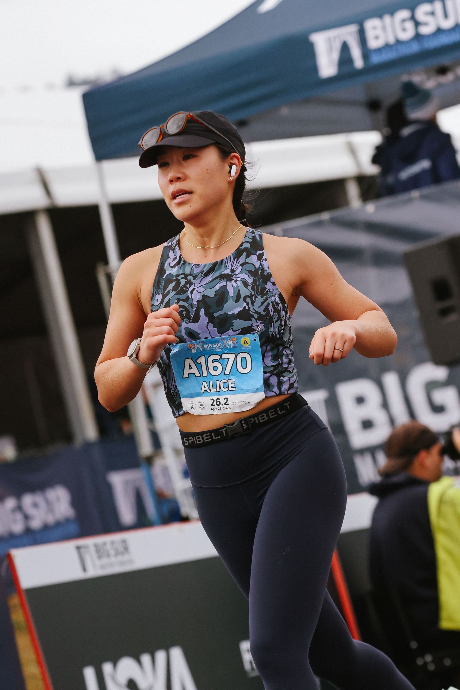 Female runner Alice wearing bib A1670 competing in the Big Sur Marathon race.
