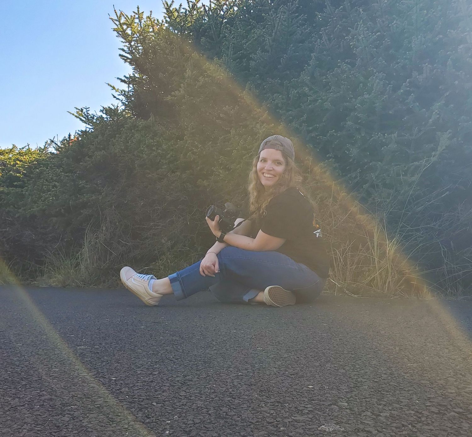 Photographer Alexa posing with camera at South Beach in Newport Oregon.