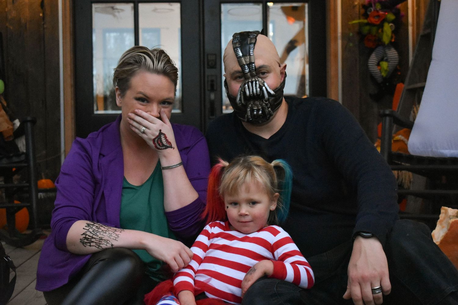 Family in Halloween costumes poses for family portrait in Newport Oregon.