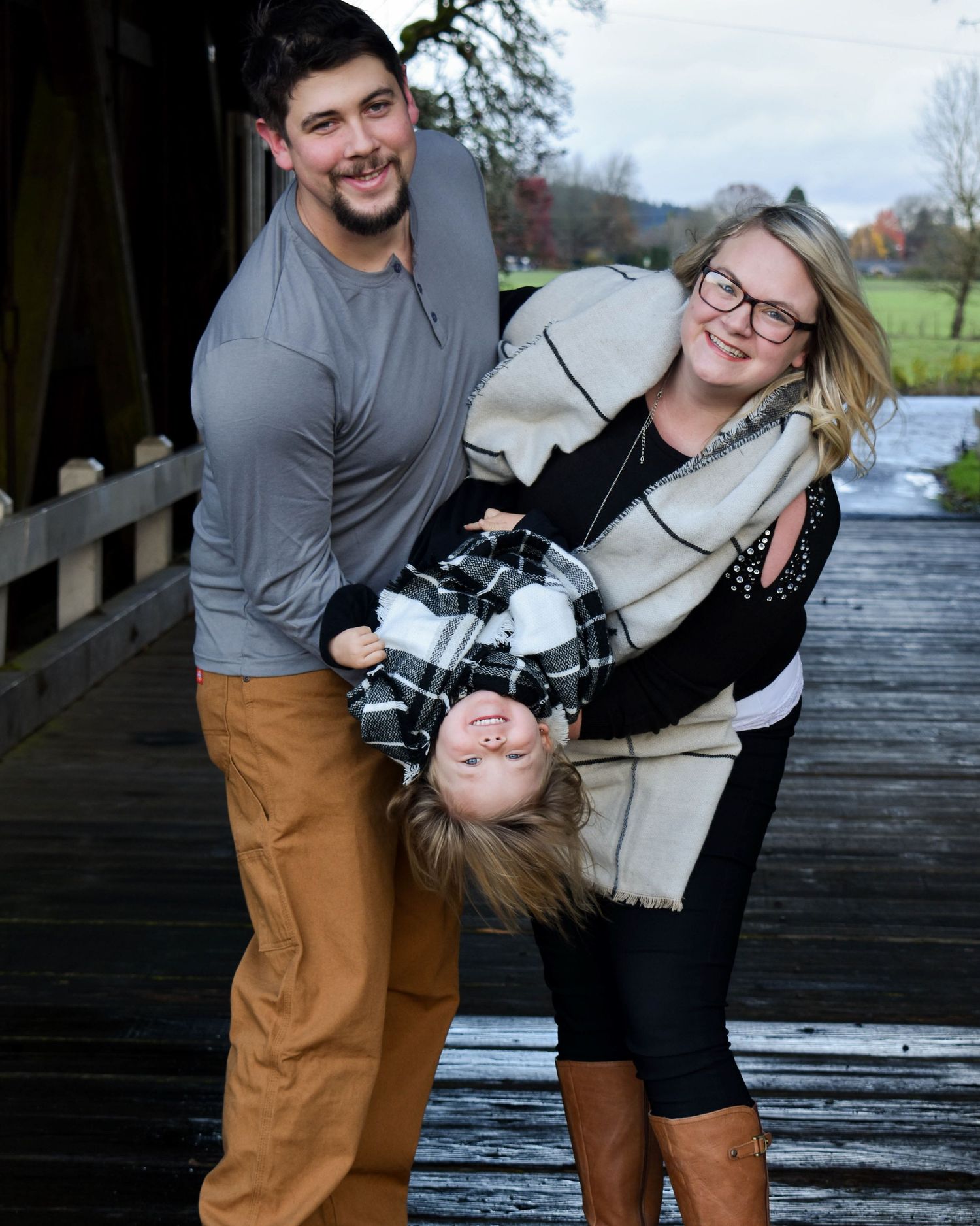 Family of three posing casually for family portrait in Newport Oregon.