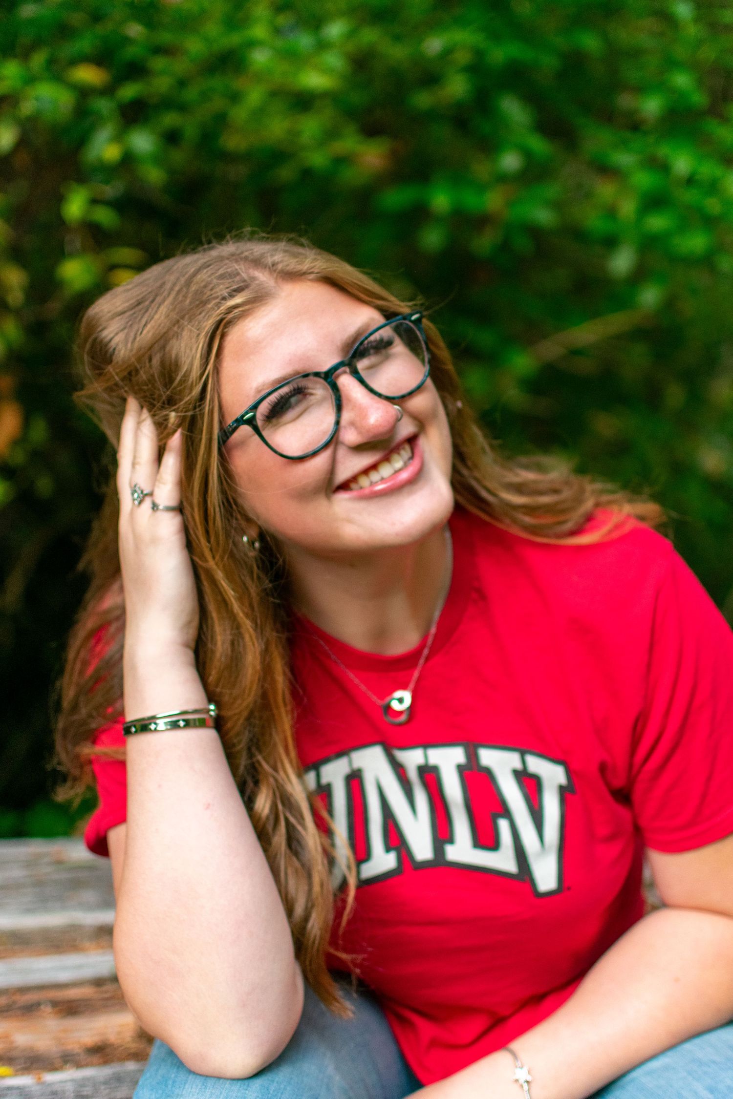 Close up of female senior wearing college t-shirt during photoshoot in Newport Oregon.