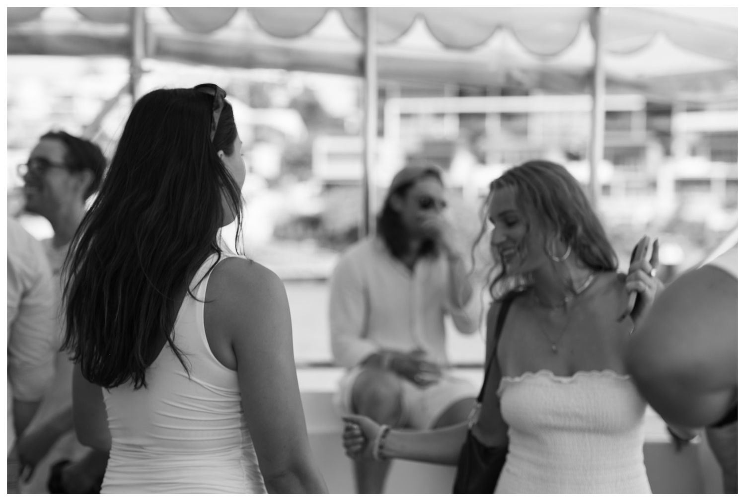 A monochrome portrait of a two women dancing at an event.
