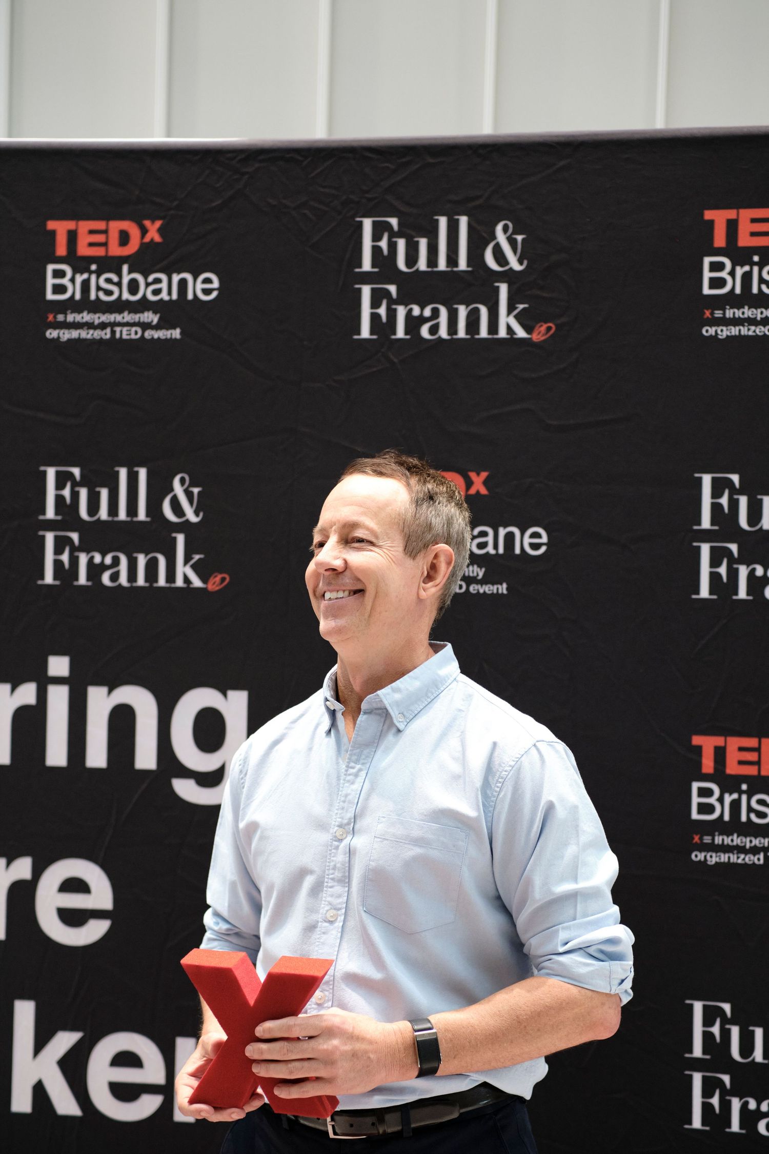 A person posing and smiling at a 