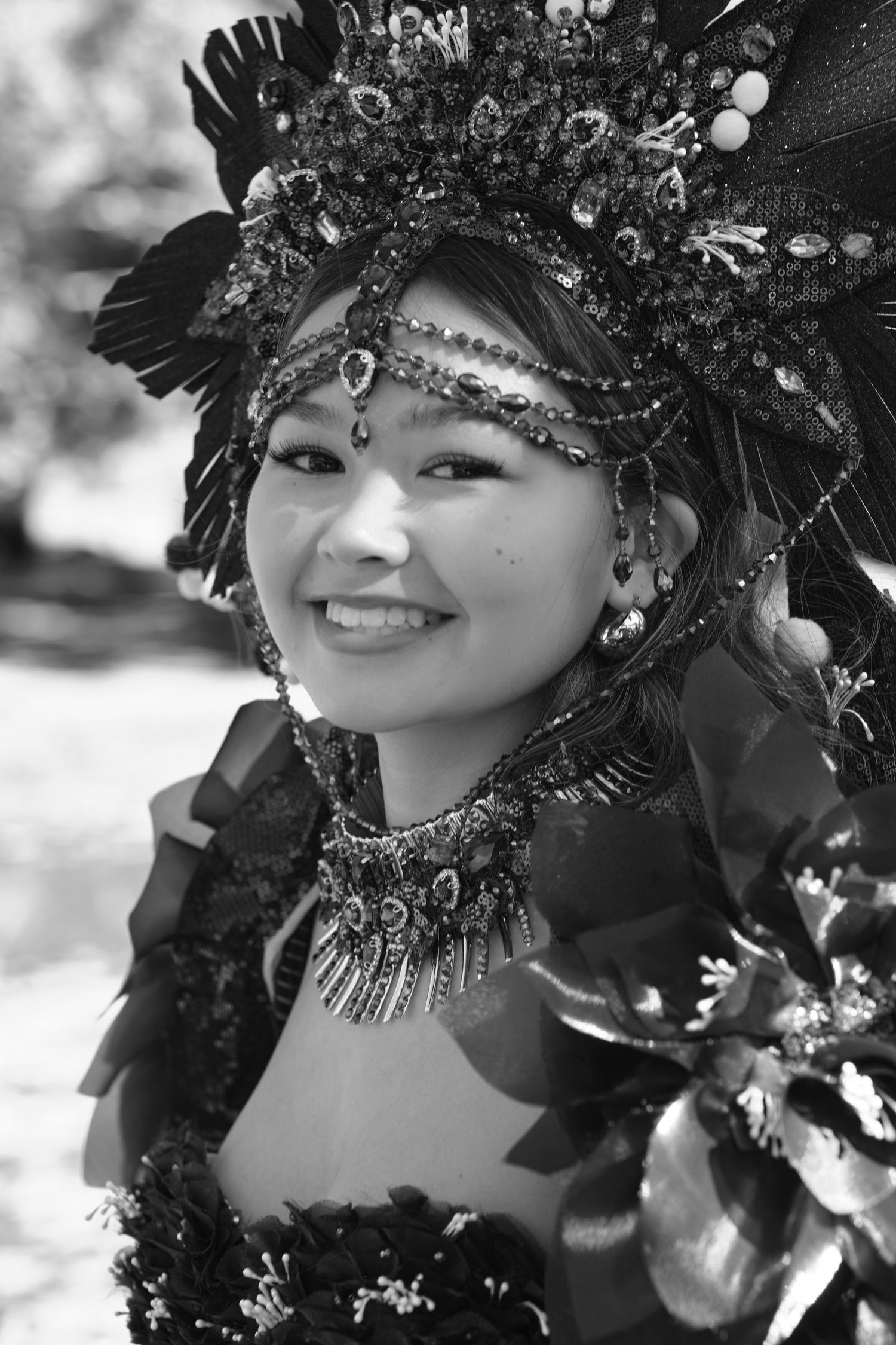 A portrait of a woman wearing a creative custome, posing outdoors.