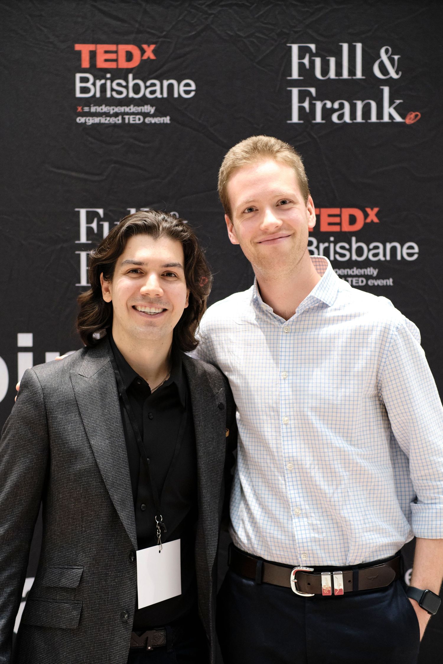 Two men smiling and posing together at a 
