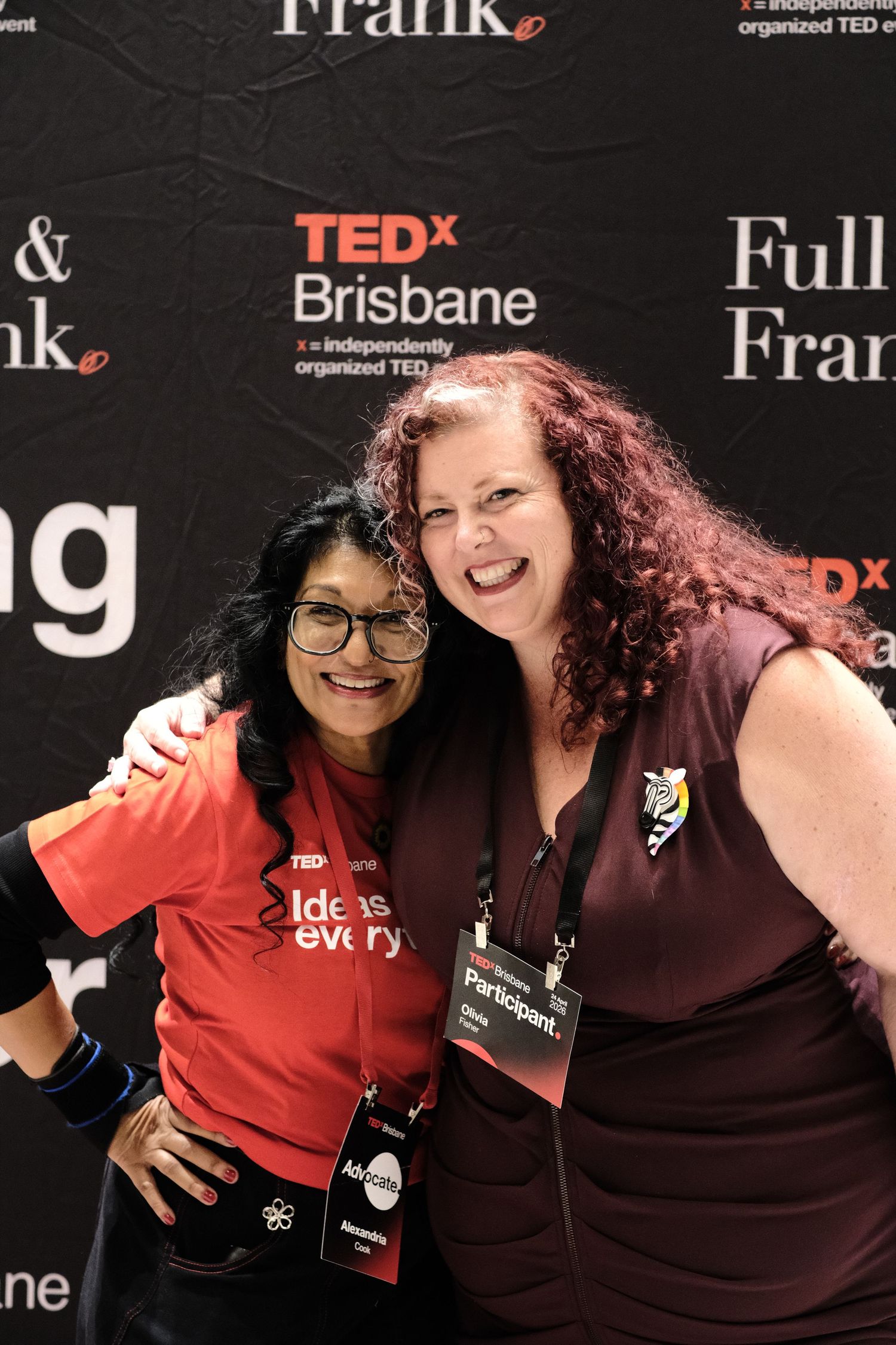 Two women smiling and posing together at the TEDxBrisbane event.