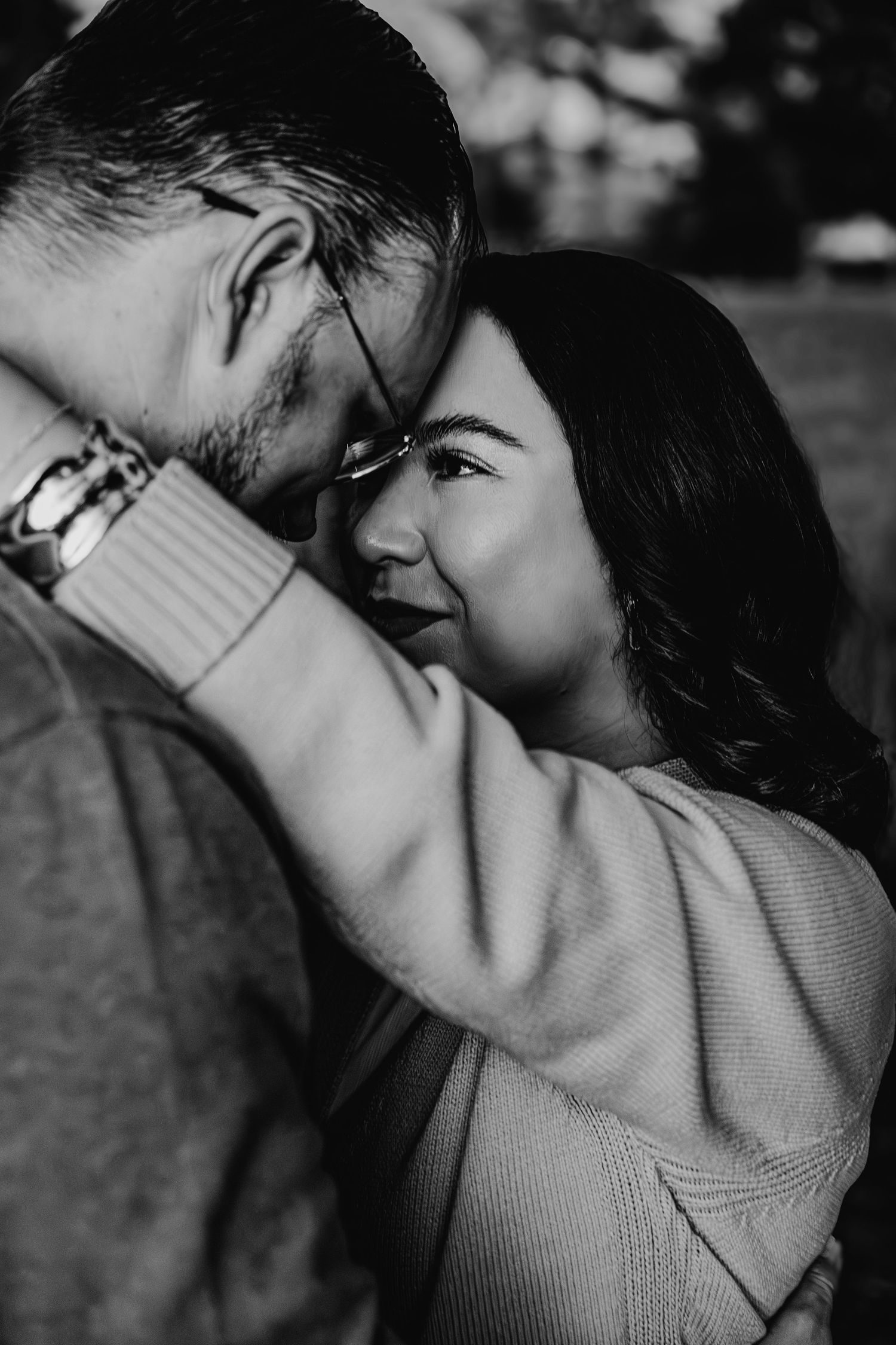 Black and white intimate couple portrait with foreheads touching tenderly.