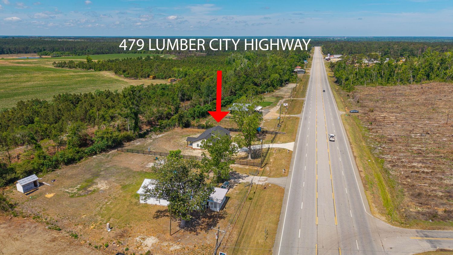 Aerial view of 479 Lumber City Highway property with open land, trees, and highway access in a rural setting.