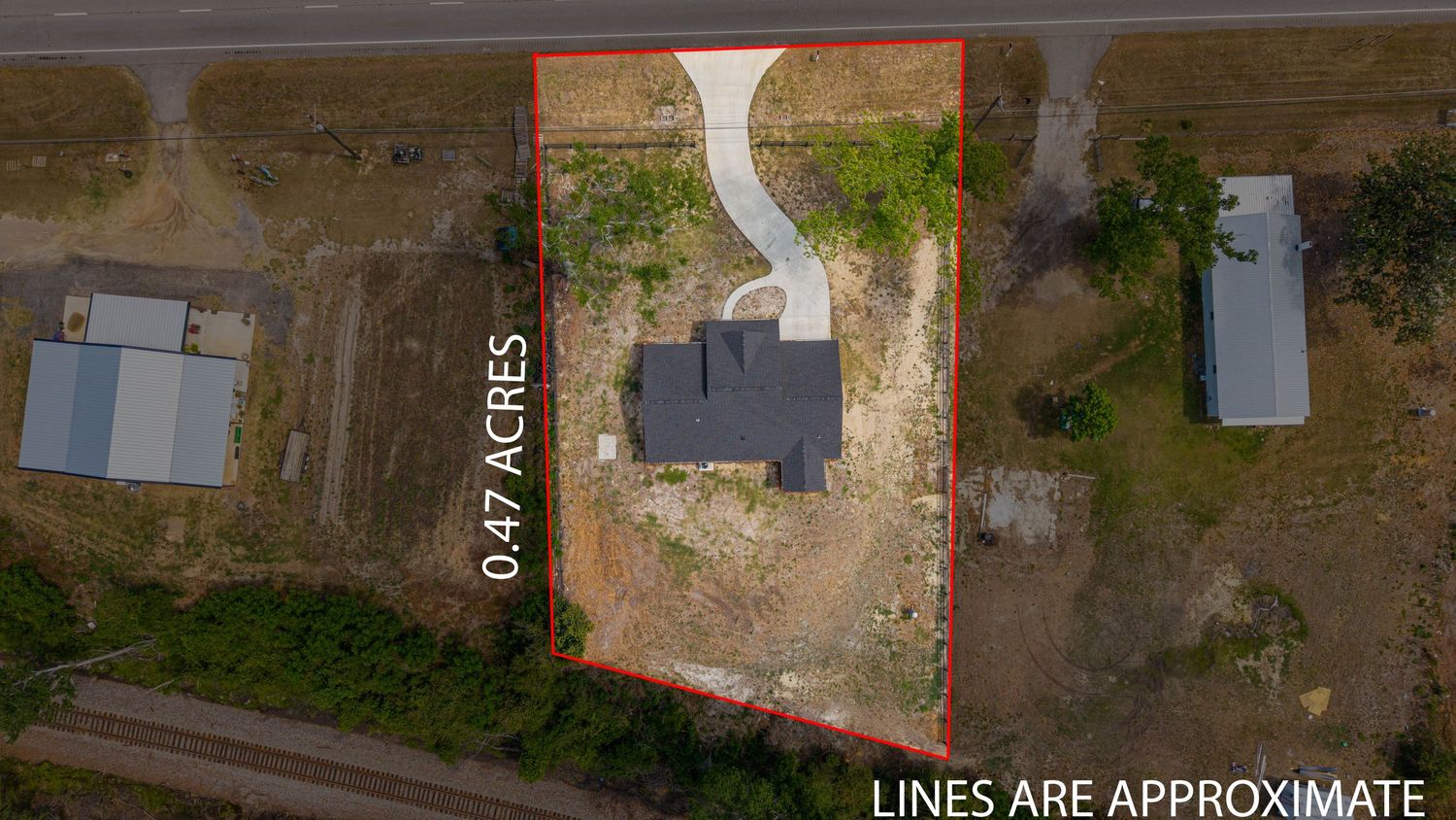 Aerial view of a 0.47-acre residential lot with a house, surrounded by open land, with boundary lines marked approximate.