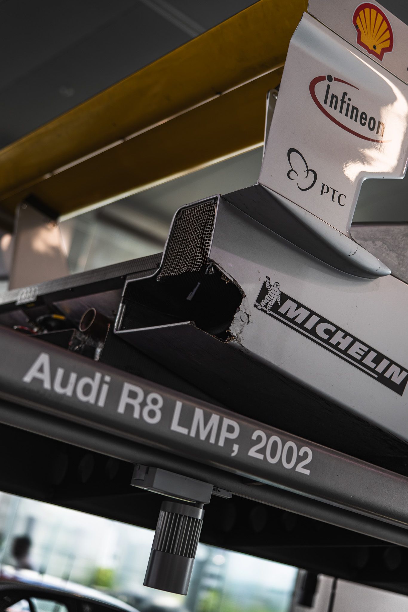 Audi R8 LMP 2002 race car underside showing Michelin and Infineon sponsor logos.