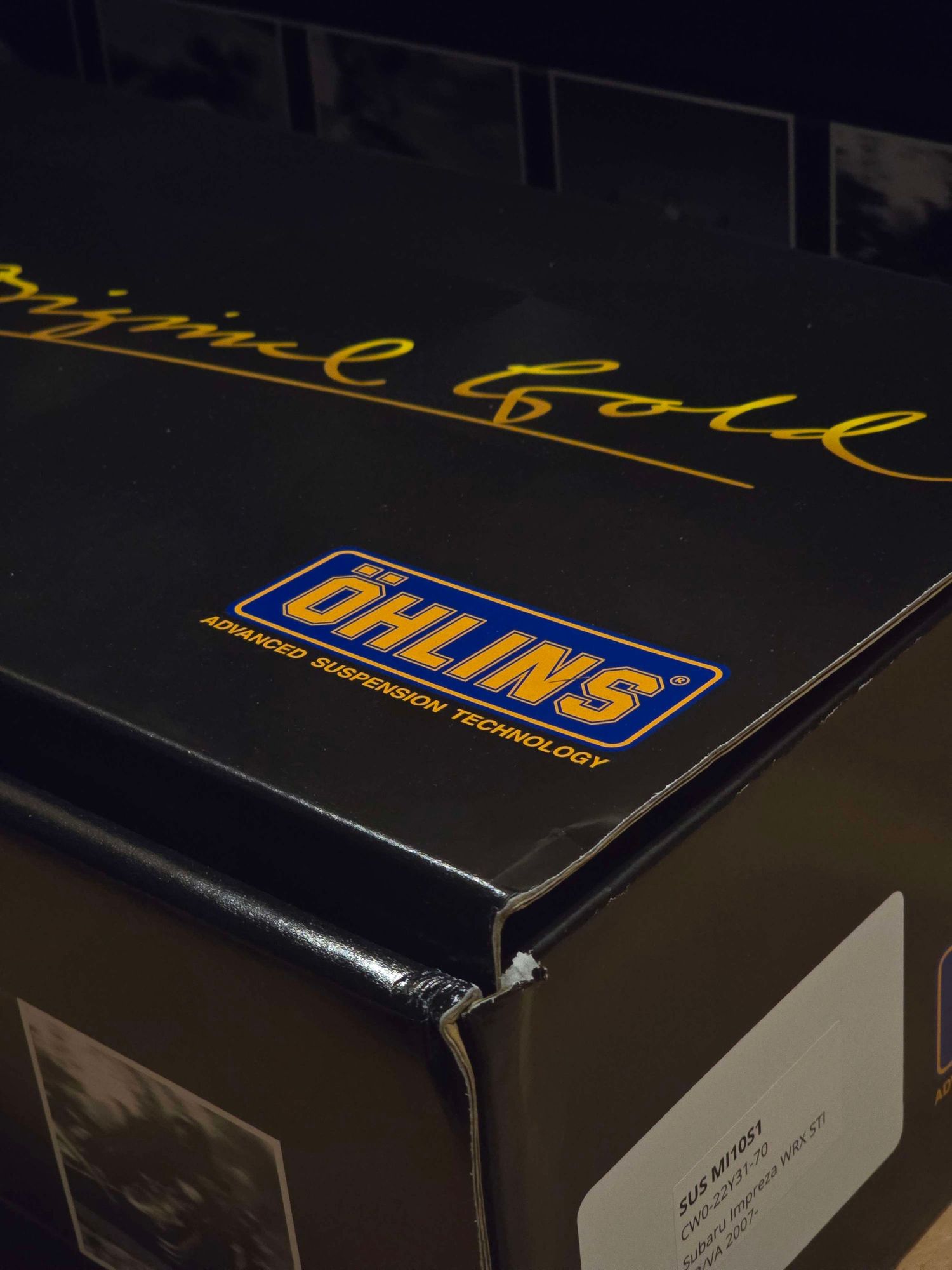 Ohlins Advanced Suspension Technology Original Gold product box corner with brand sticker.