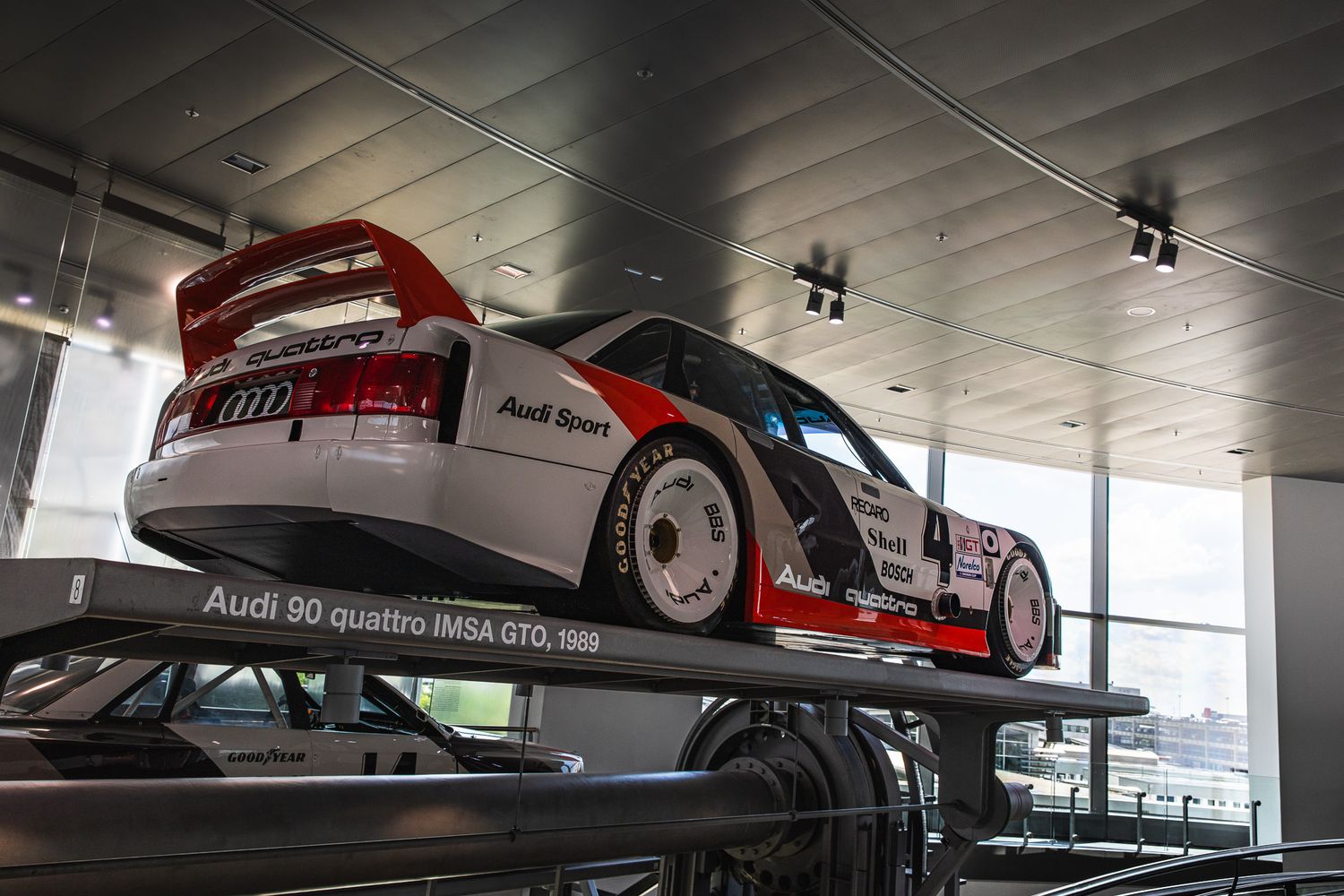 Audi 90 Quattro IMSA GTO 1989 race car elevated on display in a museum.
