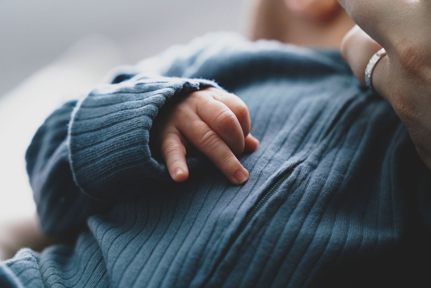 Newborn baby, at home, natural light photograph. Tiny hands.