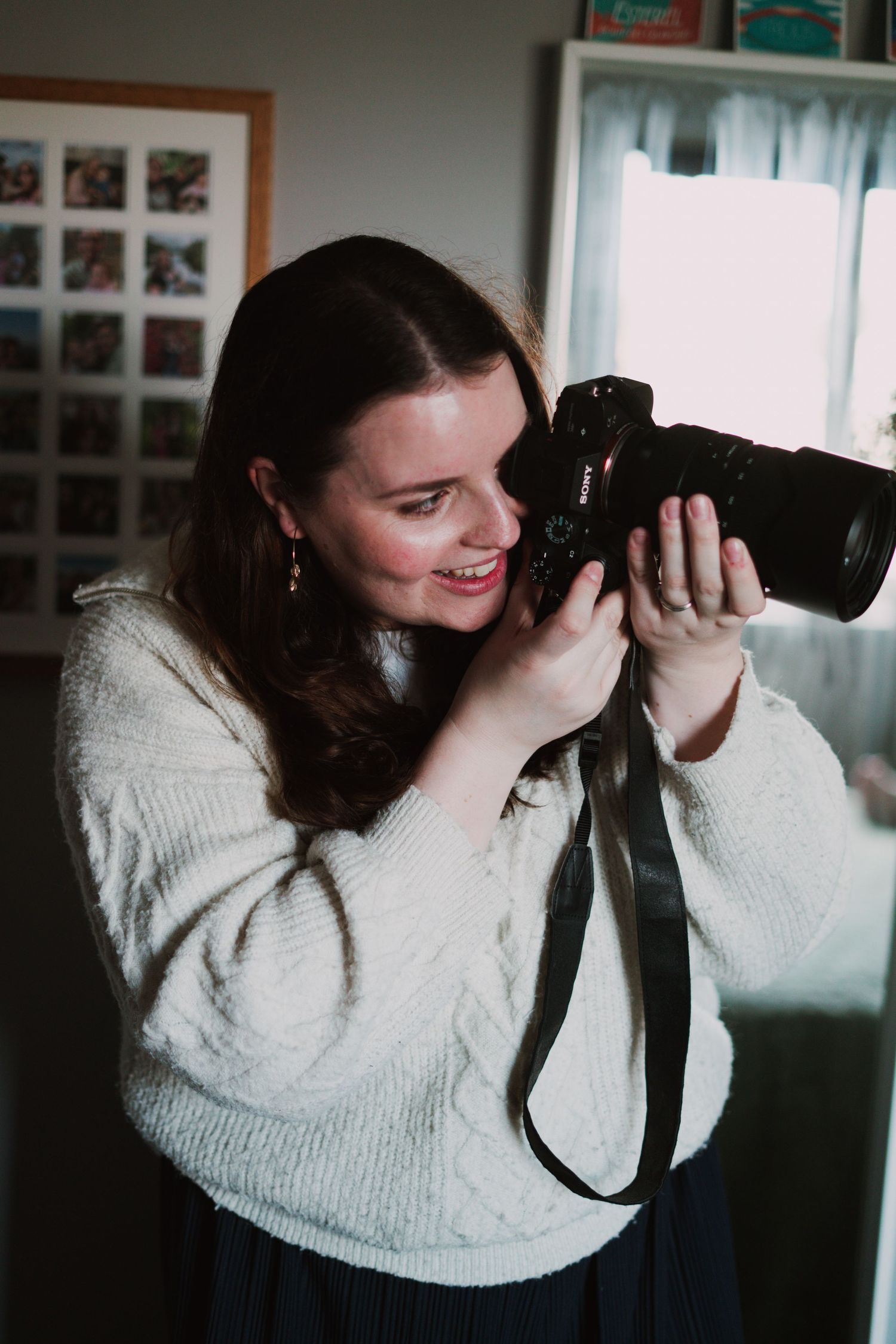 Photographer holding her camera, Suffolk.