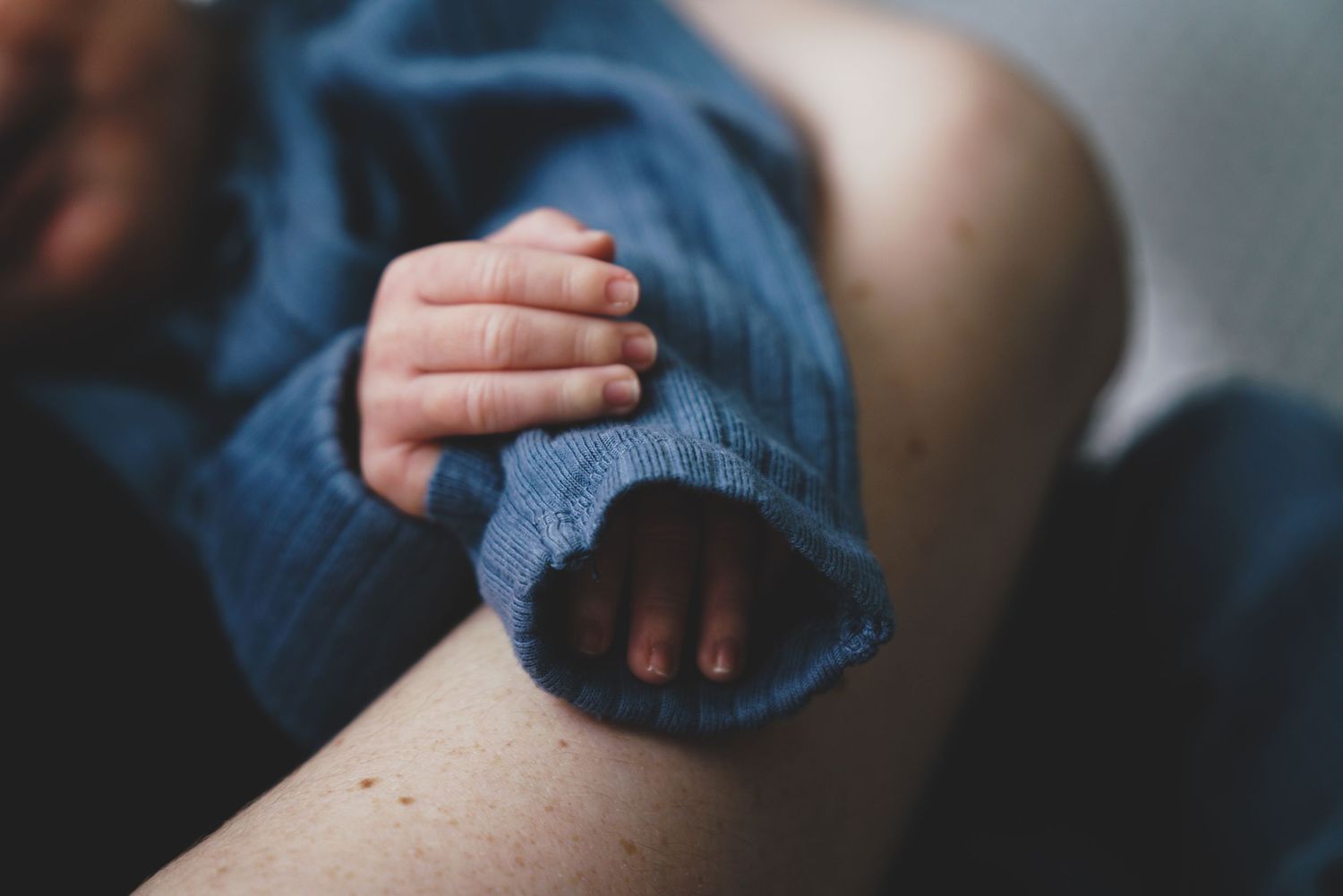 Newborn baby, at home, natural light photograph. Tiny hands.