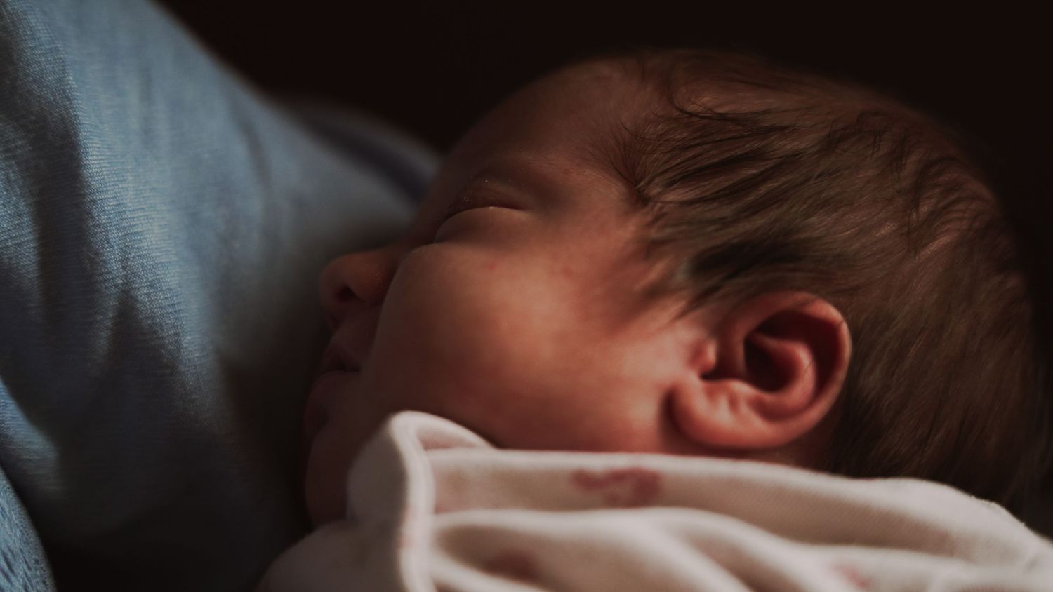 Newborn baby, at home, natural light photograph. Suffolk.