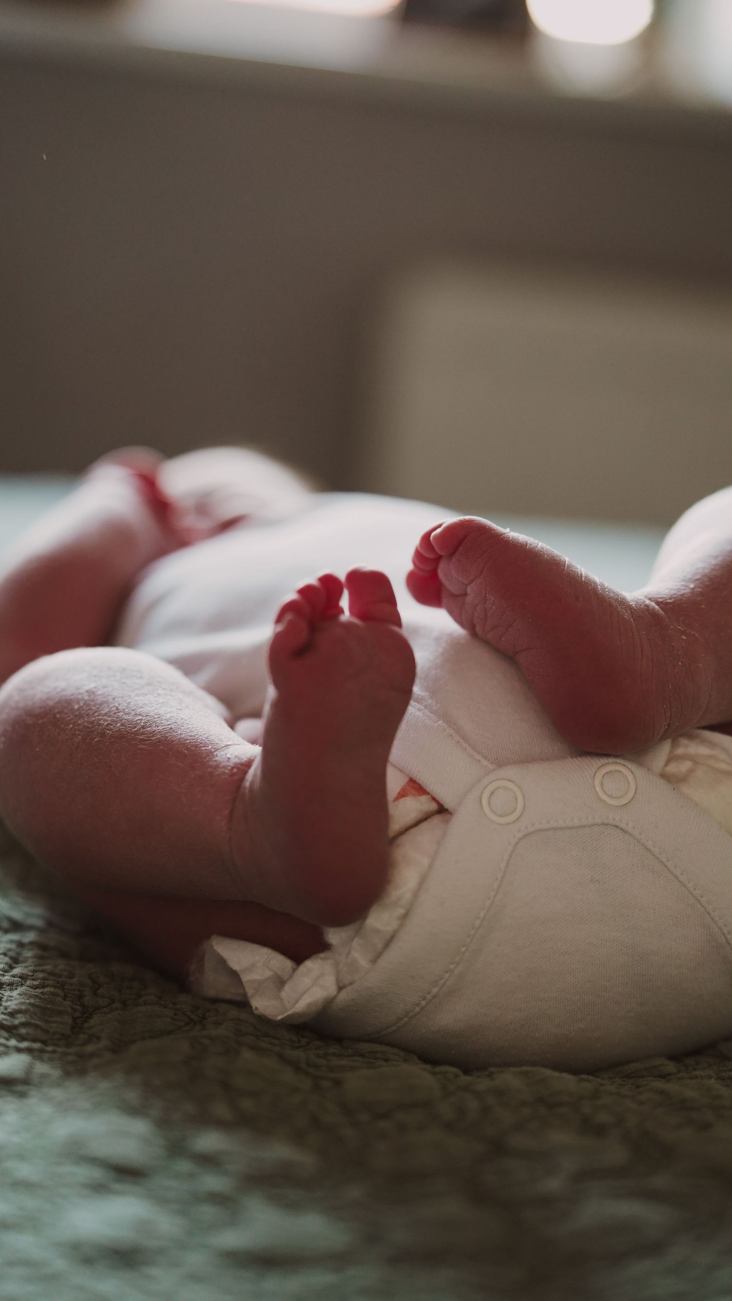 Newborn baby, at home, natural light photograph. Tiny feet. Suffolk.