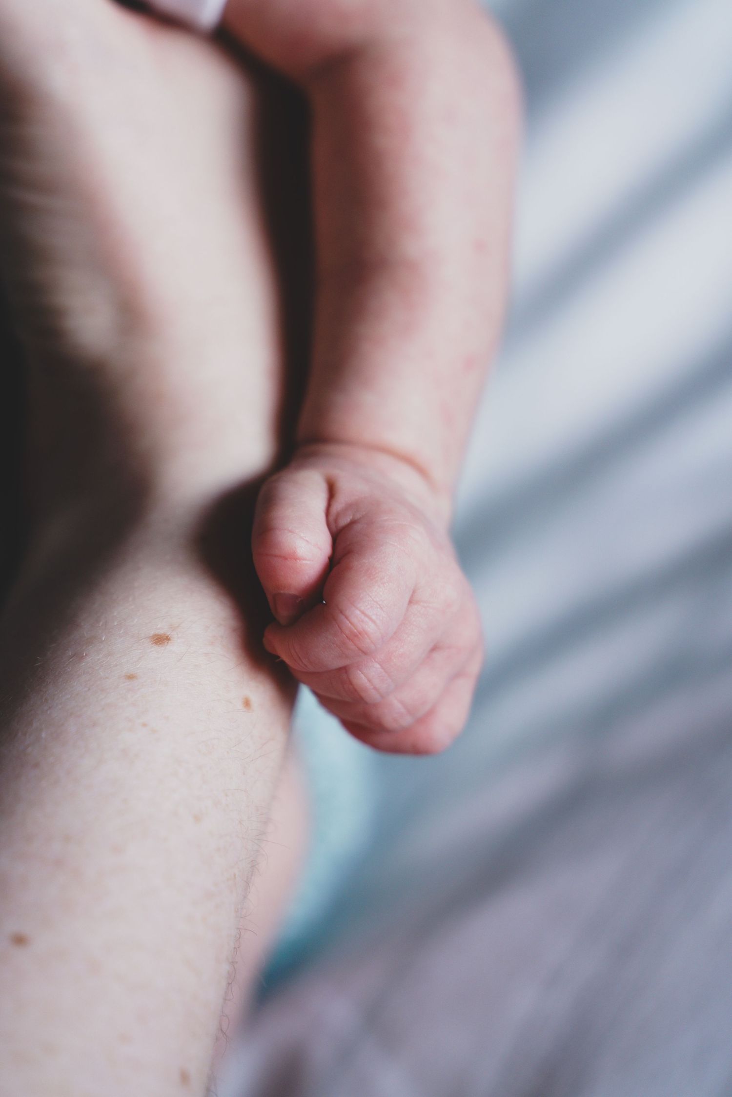 Newborn baby, at home, natural light photograph. Tiny hands.