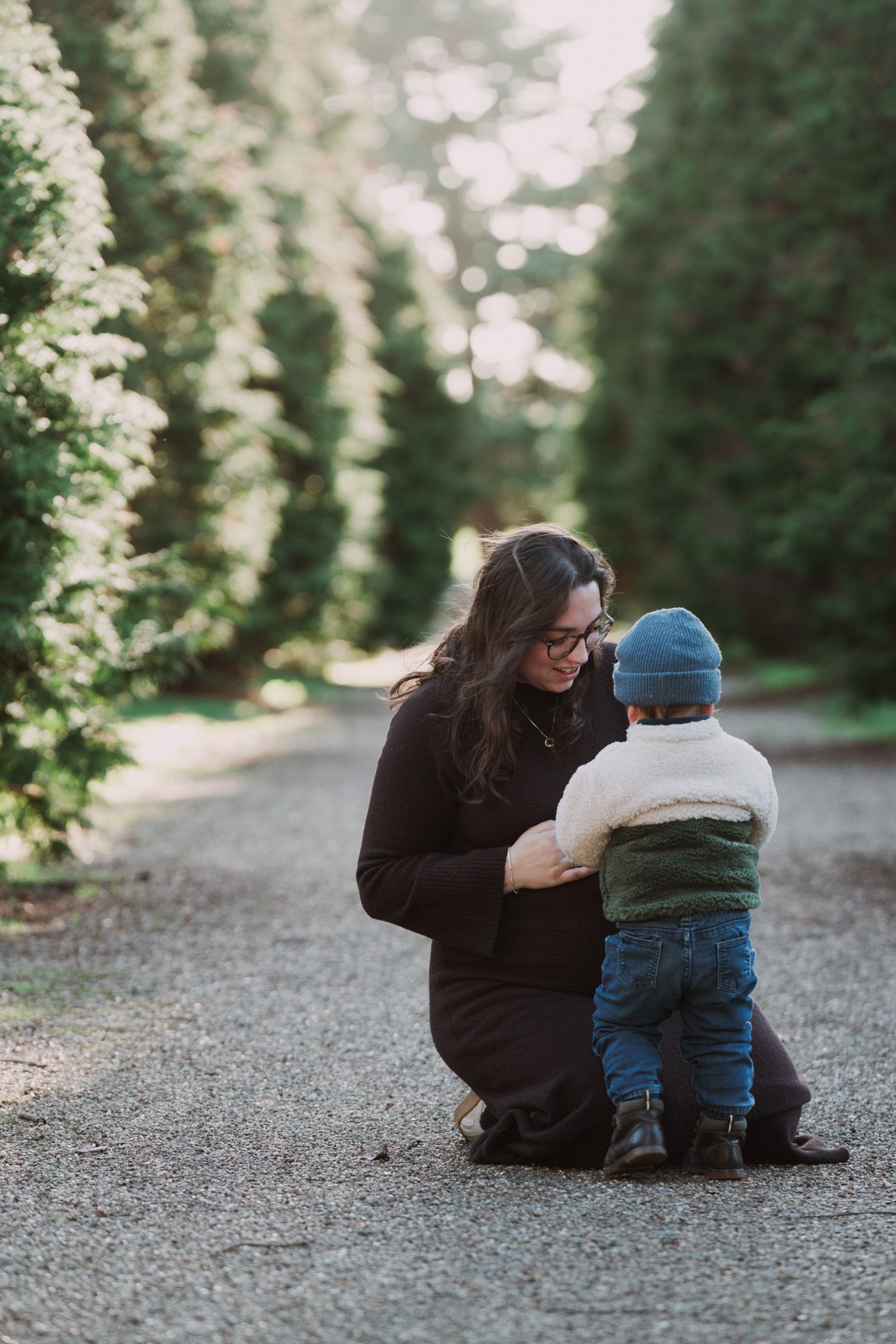 Natural light, outdoor family and maternity photos in Suffolk. Pregnant mother and child.
