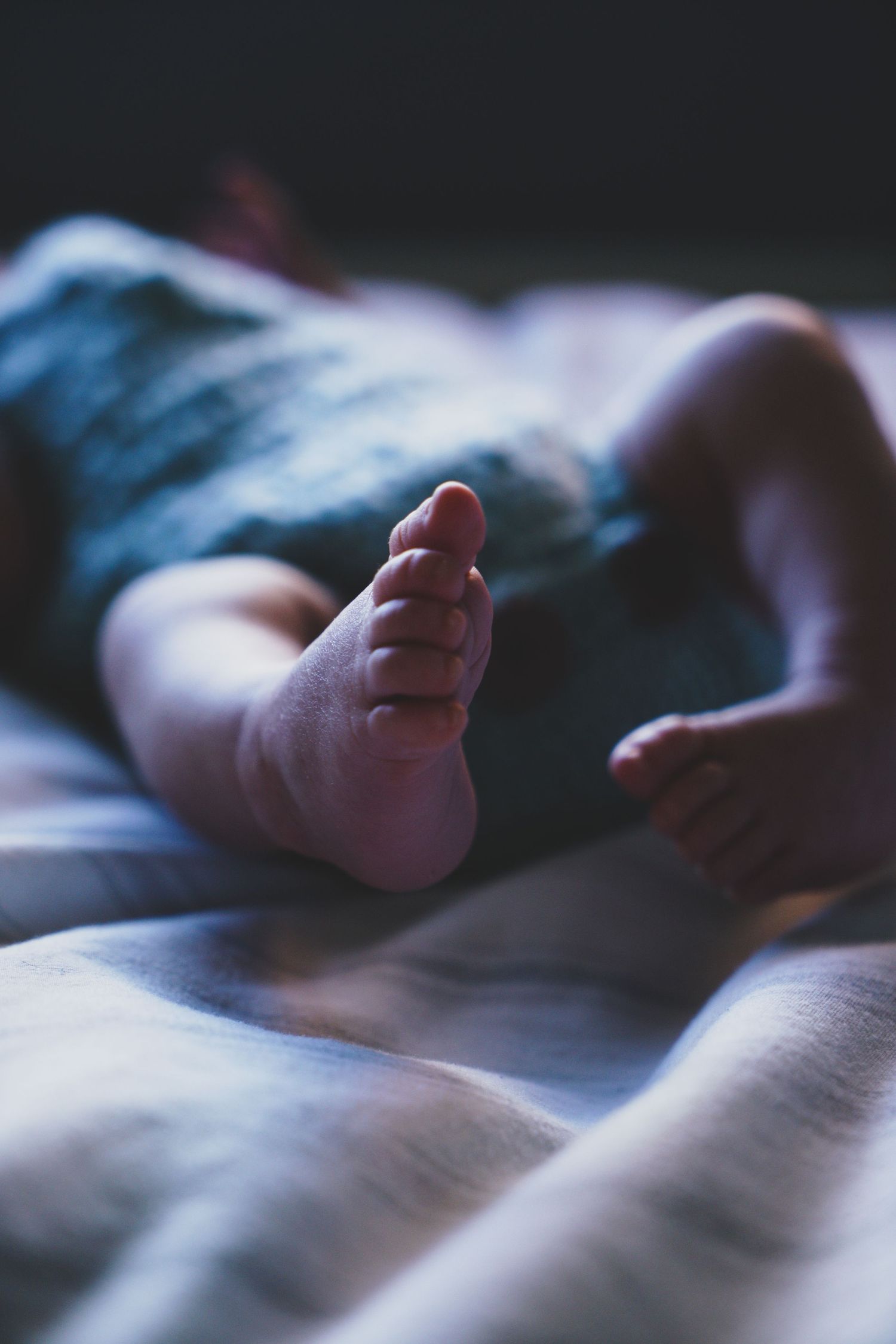 Newborn baby, at home, natural light photograph. Tiny feet.