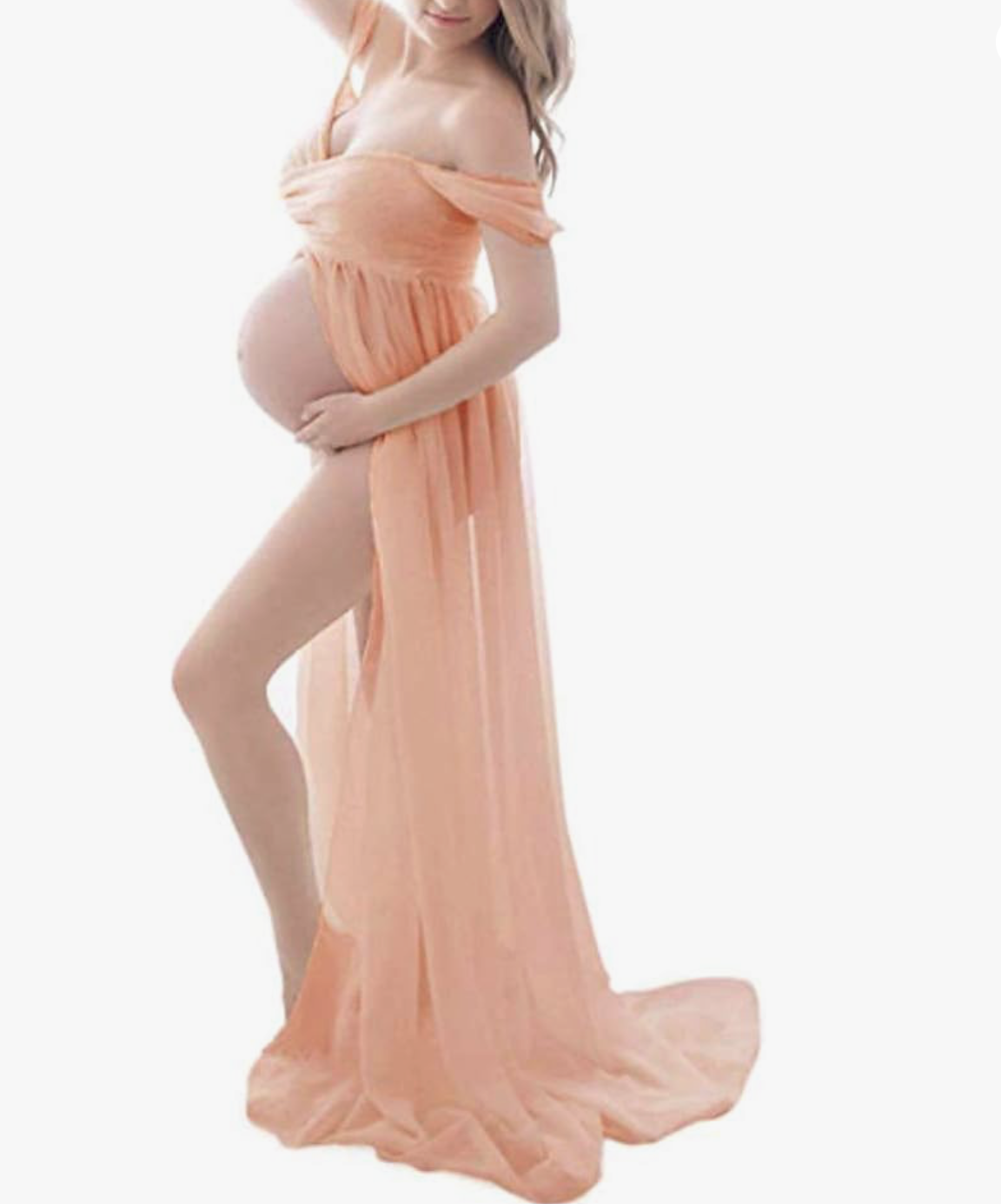 Pregnant woman in peach off-shoulder split chiffon maternity gown with flowing fabric trail.