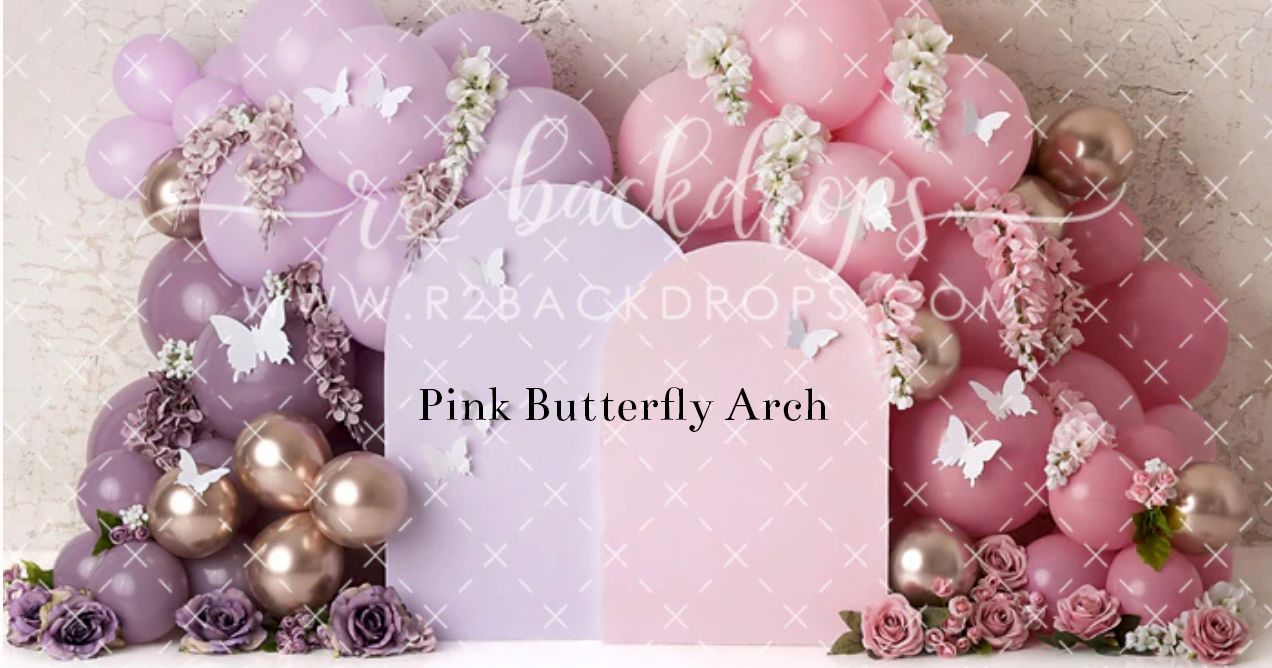 Pink and purple balloon arch with white butterflies and flowers children's photography backdrop.