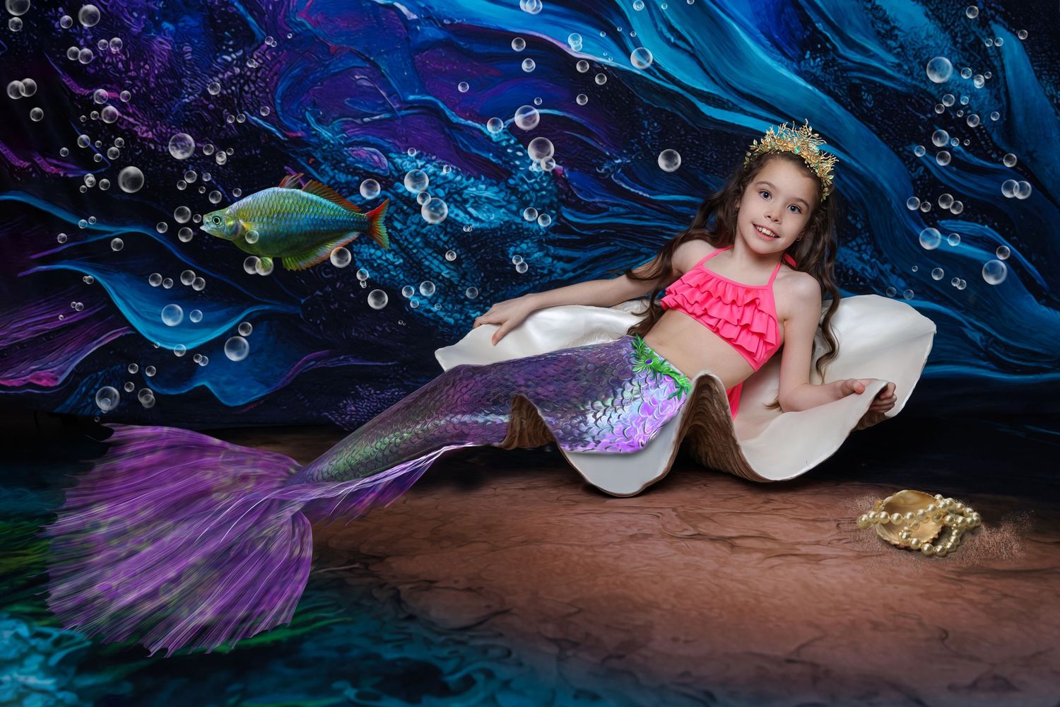 A young girl dressed as a mermaid with a purple tail reclines in a giant shell on an ocean backdrop.