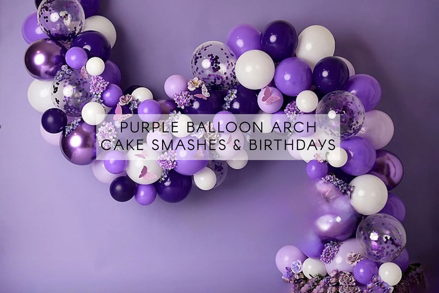 Purple balloon arch with mixed purple, white, and confetti balloons for cake smashes and birthday photo backdrops.