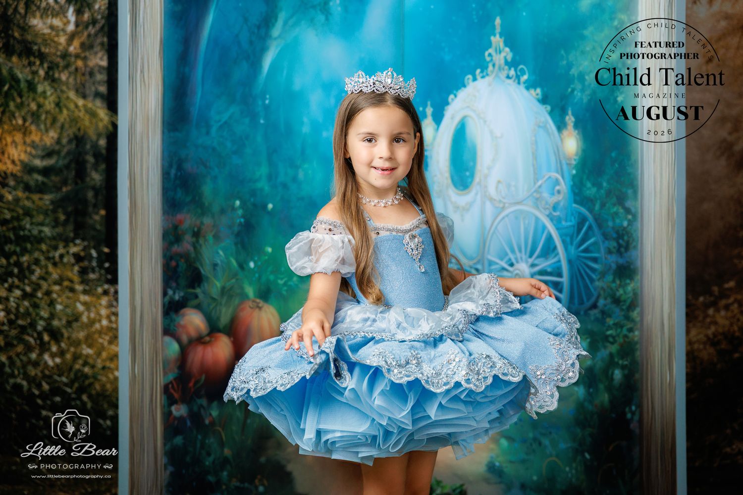Young girl in blue Cinderella dress and crown poses in front of fairy tale carriage backdrop for Child Talent photography.