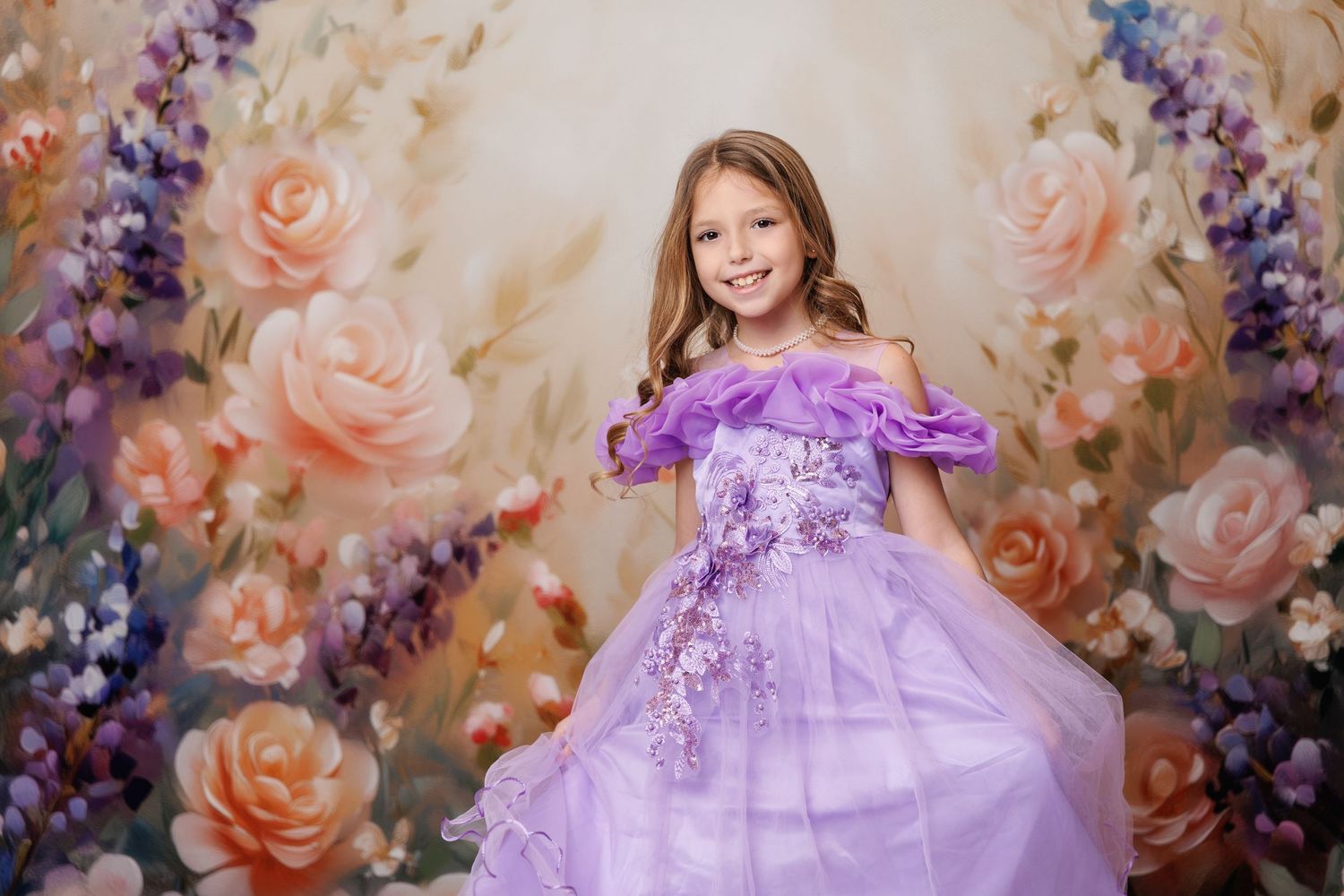 Young girl in purple floral ball gown smiling before a painted rose floral backdrop.