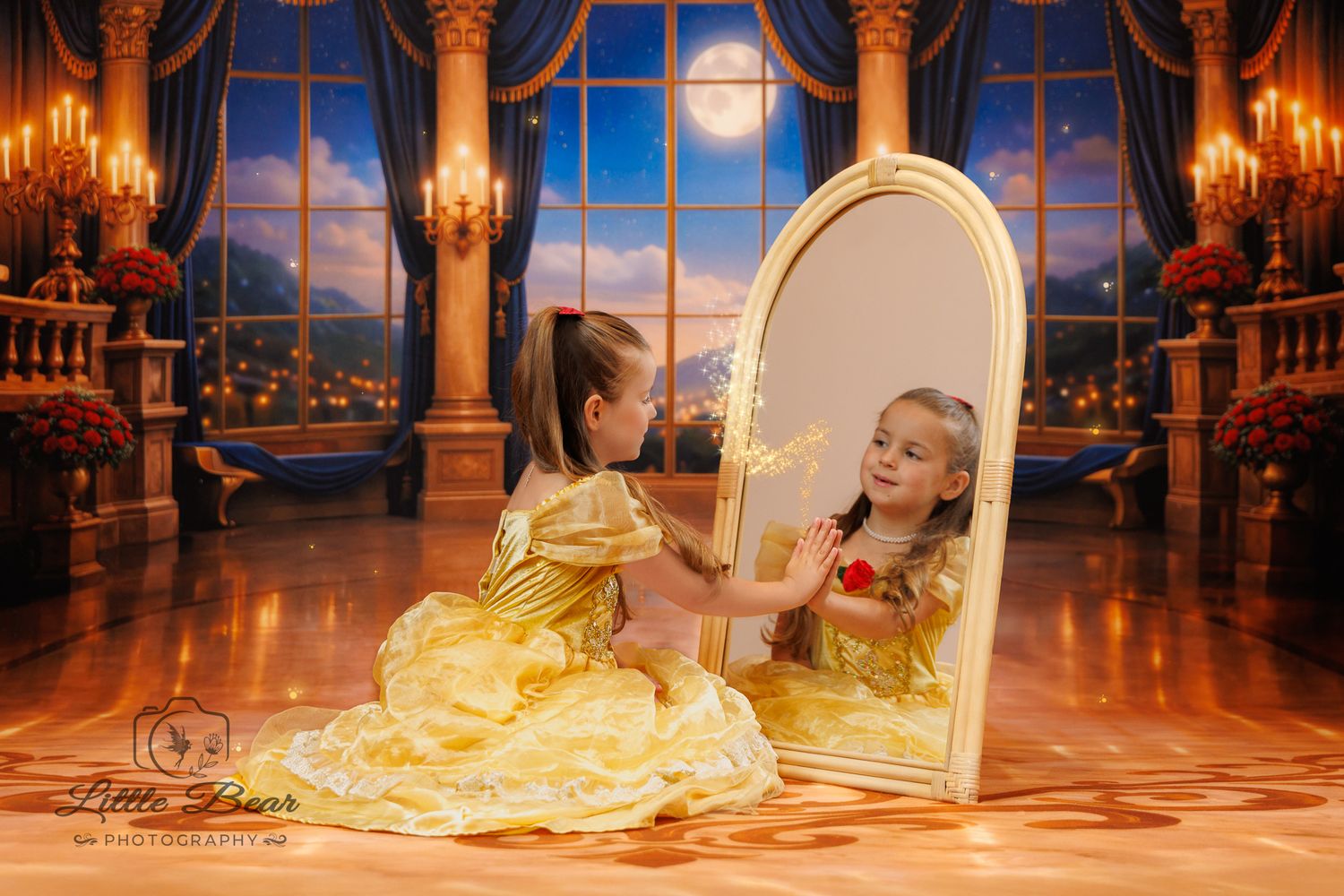 Girl in yellow Belle gown touches mirror reflection in enchanted castle setting with moonlit windows.