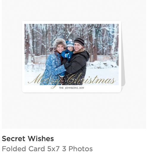 Secret Wishes folded 5x7 Christmas card featuring a family photo in a snowy winter setting with gold Merry Christmas text.