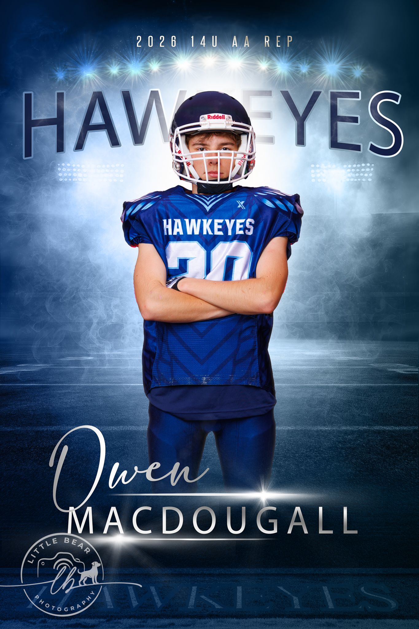 Owen MacDougall, 2028 Hawkeyes 14U AA Rep football player #20, posing arms crossed in stadium lighting.