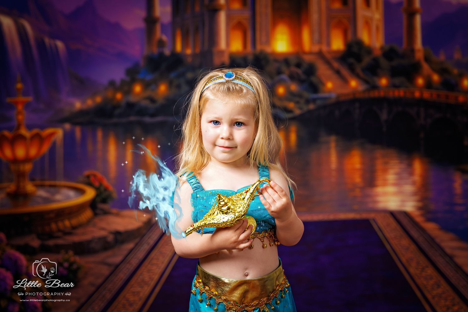 Young girl in teal Jasmine costume holds glowing magic lamp against enchanted palace backdrop.