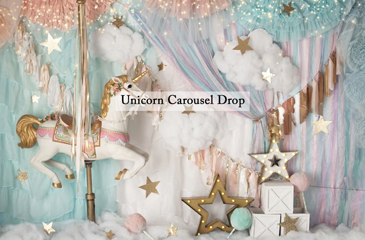 Unicorn carousel drop backdrop with pastel curtains, gold stars, clouds, and a white horse for birthday photo shoots.