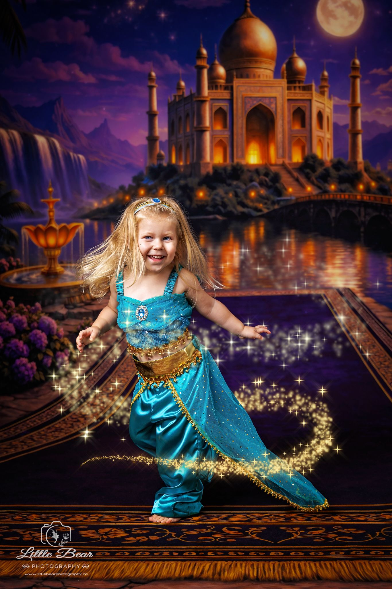 Young girl in teal Princess Jasmine costume poses on magic carpet with sparkles, Taj Mahal backdrop at night.