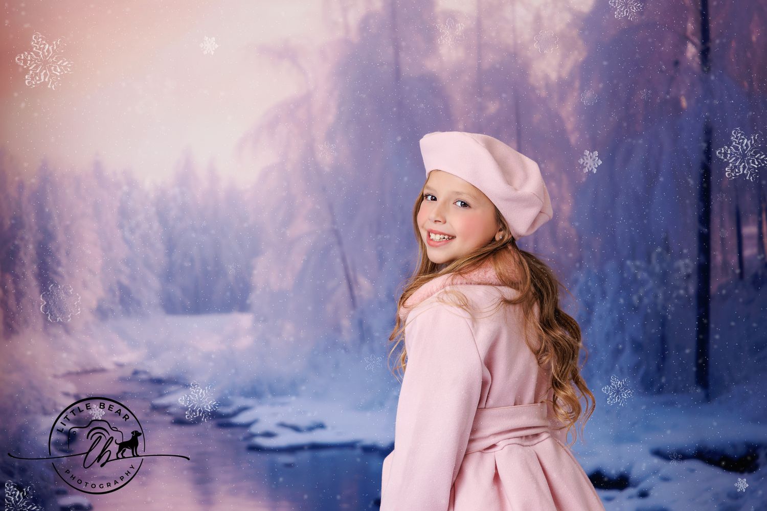 Young girl in pink coat and beret poses in snowy winter wonderland photography backdrop.