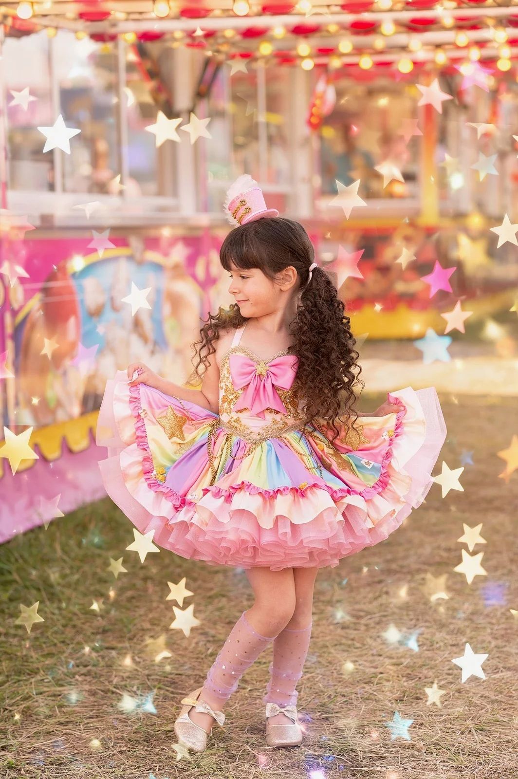 Young girl in colorful rainbow tutu dress twirling at a carnival, surrounded by sparkling stars.