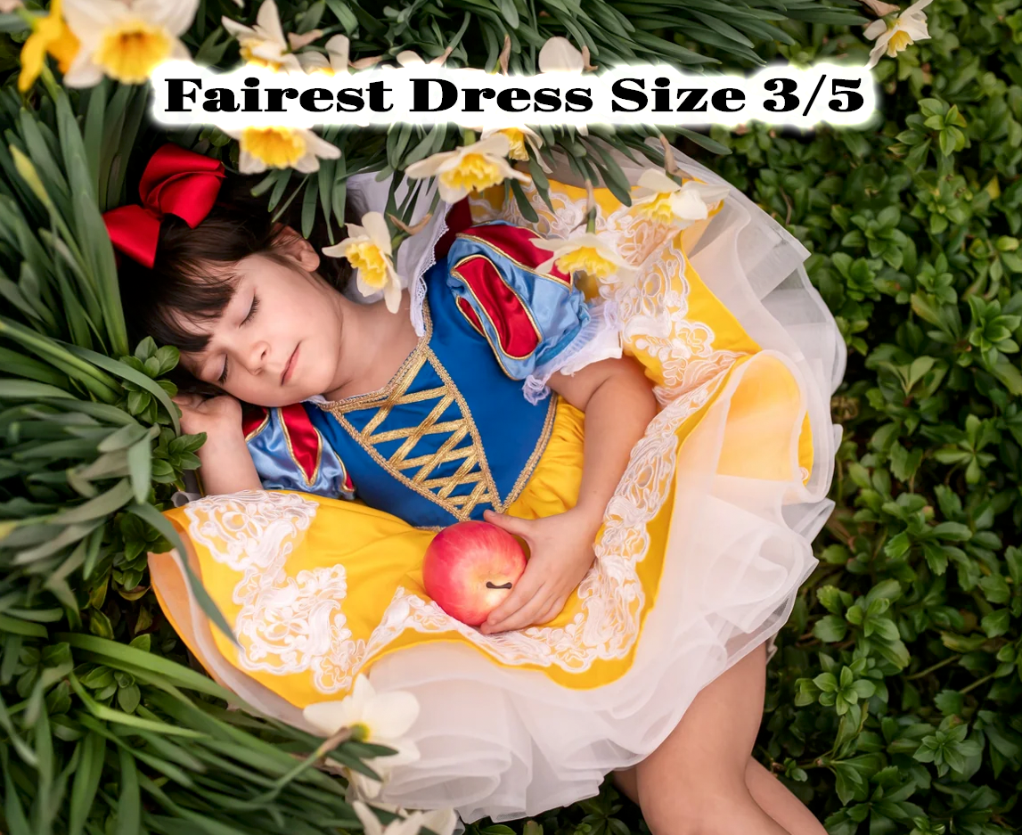 Child in Snow White costume dress size 3/5 holding apple, lying among daffodils in yellow and blue fairest dress.