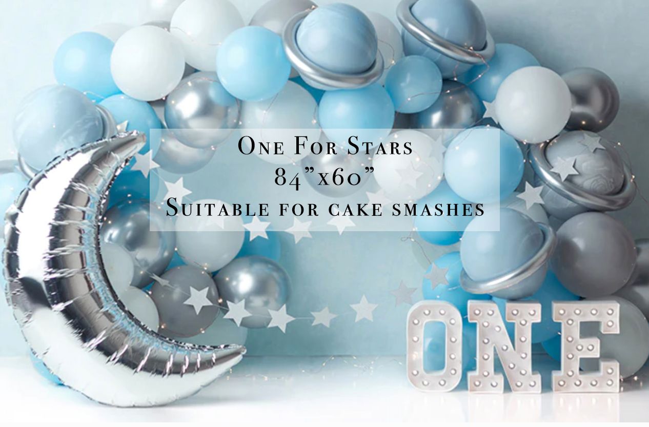 Blue and silver balloon arch birthday backdrop with moon, stars, and ONE sign, 84x60 inches, suitable for cake smashes.