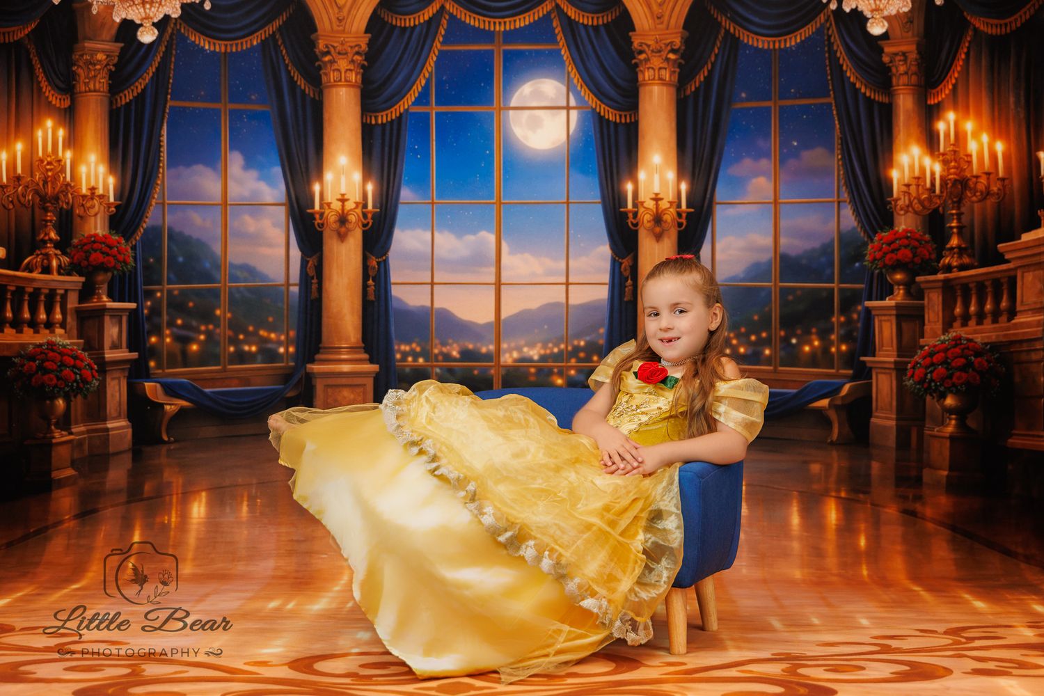 Young girl in golden Beauty and the Beast gown poses regally in an enchanted ballroom setting with moonlit windows.