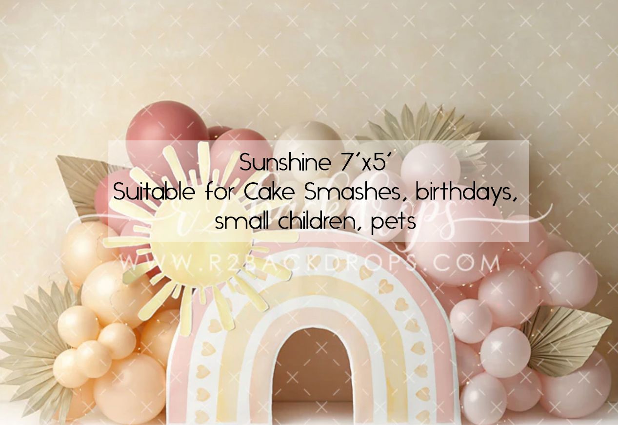 Sunshine 7x5 photography backdrop with pastel rainbow, pink balloons, and floral accents, ideal for cake smashes and birthdays.
