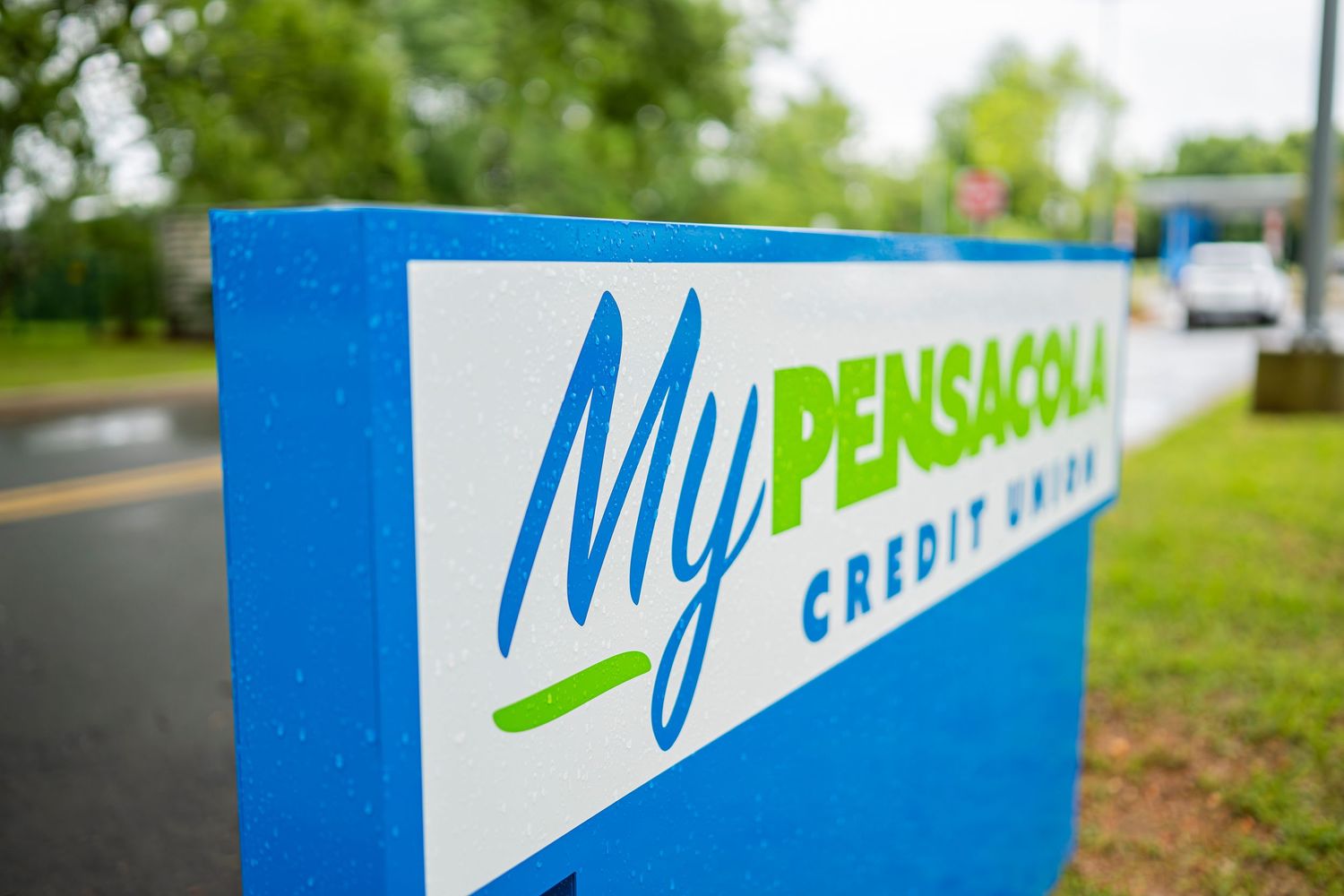 My Pensacola Credit Union blue outdoor sign on a rainy day.