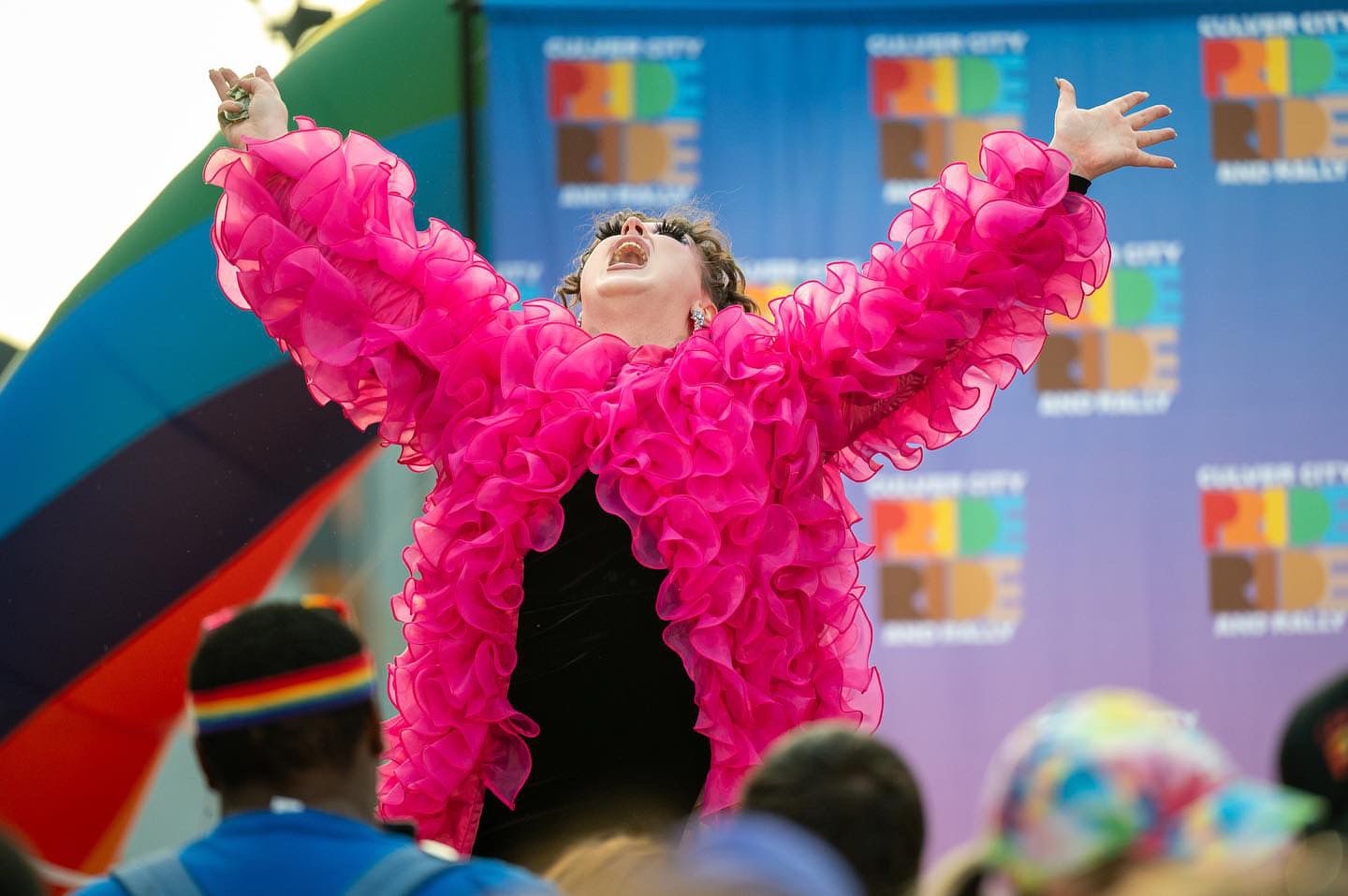 Photograph of YUQ Studios Director of Production Operations, Betti. Performing at a Pride festival.