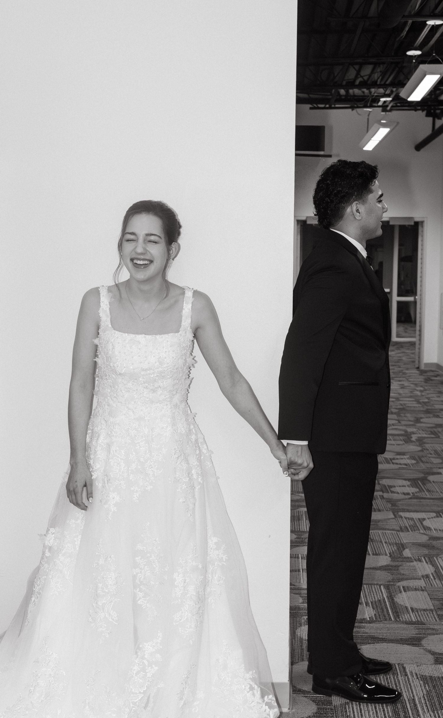 Intimate first touch first prayer moment between bride and groom before their wedding ceremony in Tampa Florida