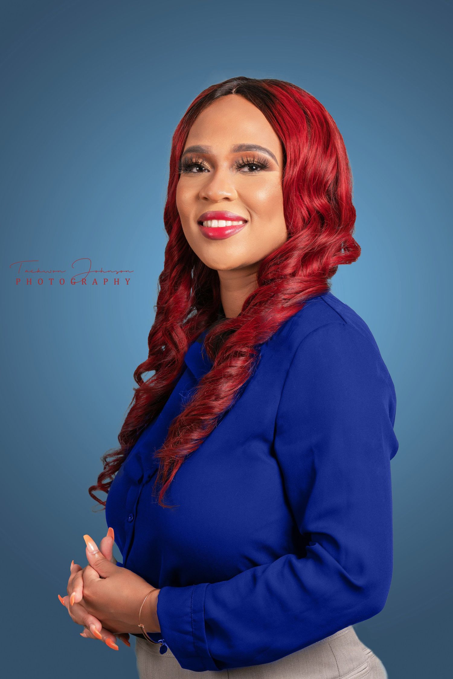 Studio portrait in royal blue blazer against blue background.