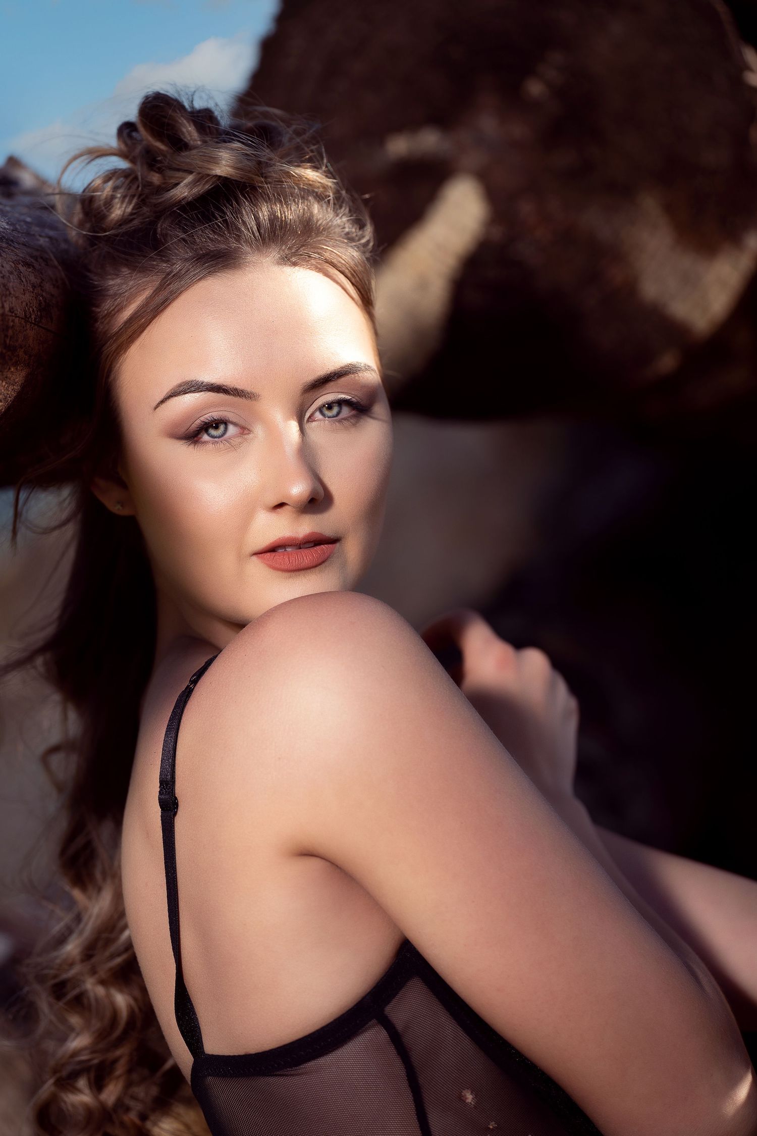 Vintage-inspired boudoir photo with dramatic lighting and shadows.